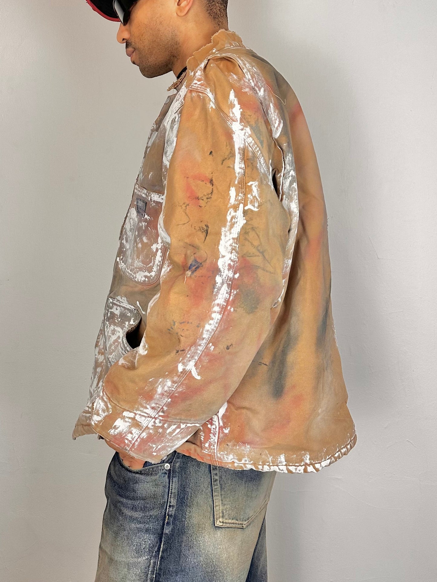 Right side of ASTROBOI* Big Smith tan workwear jacket with quilted lining, boxy fit, deconstructed collar, and black red white paint detailing, size XL.