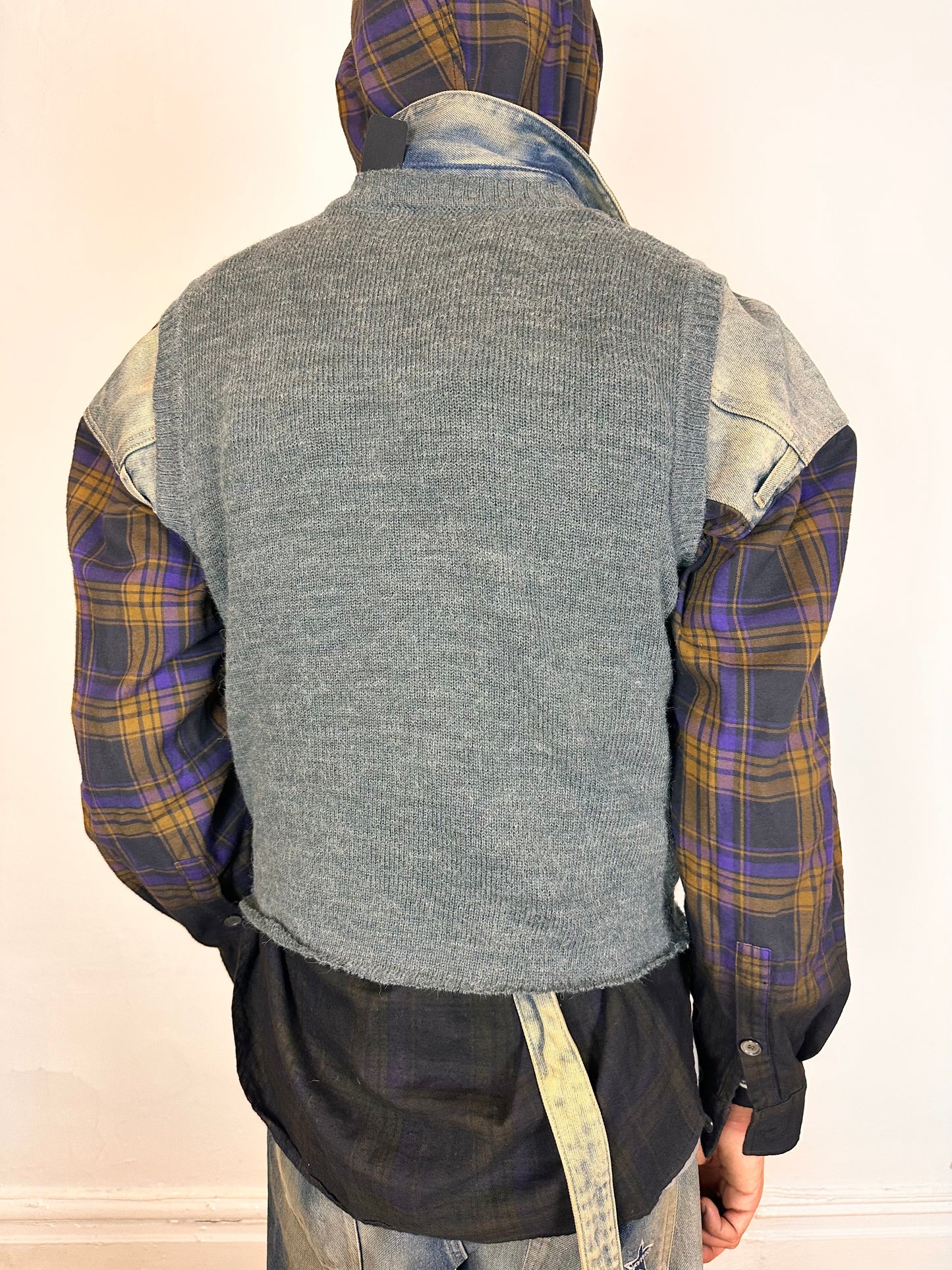 Back of ASTROBOI* gray cropped argyle sweater vest in size Large with burgundy and purple pattern, raw hem, and relaxed fit. Custom made in NYC.