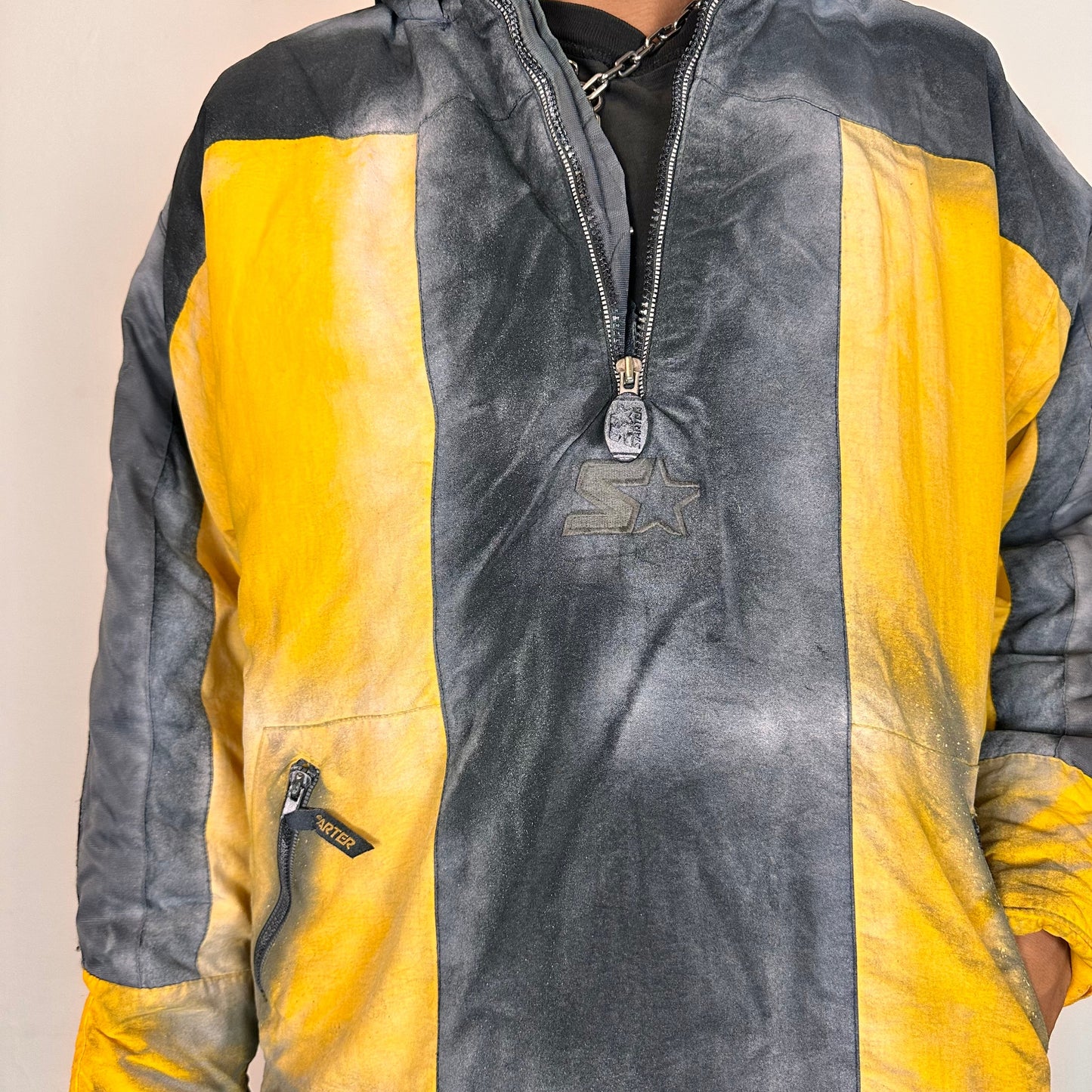 Cover of ASTROBOI* x Starter yellow and black airbrushed puffer jacket with grey sleeves, reflective taping, and adjustable toggles, men’s XL.