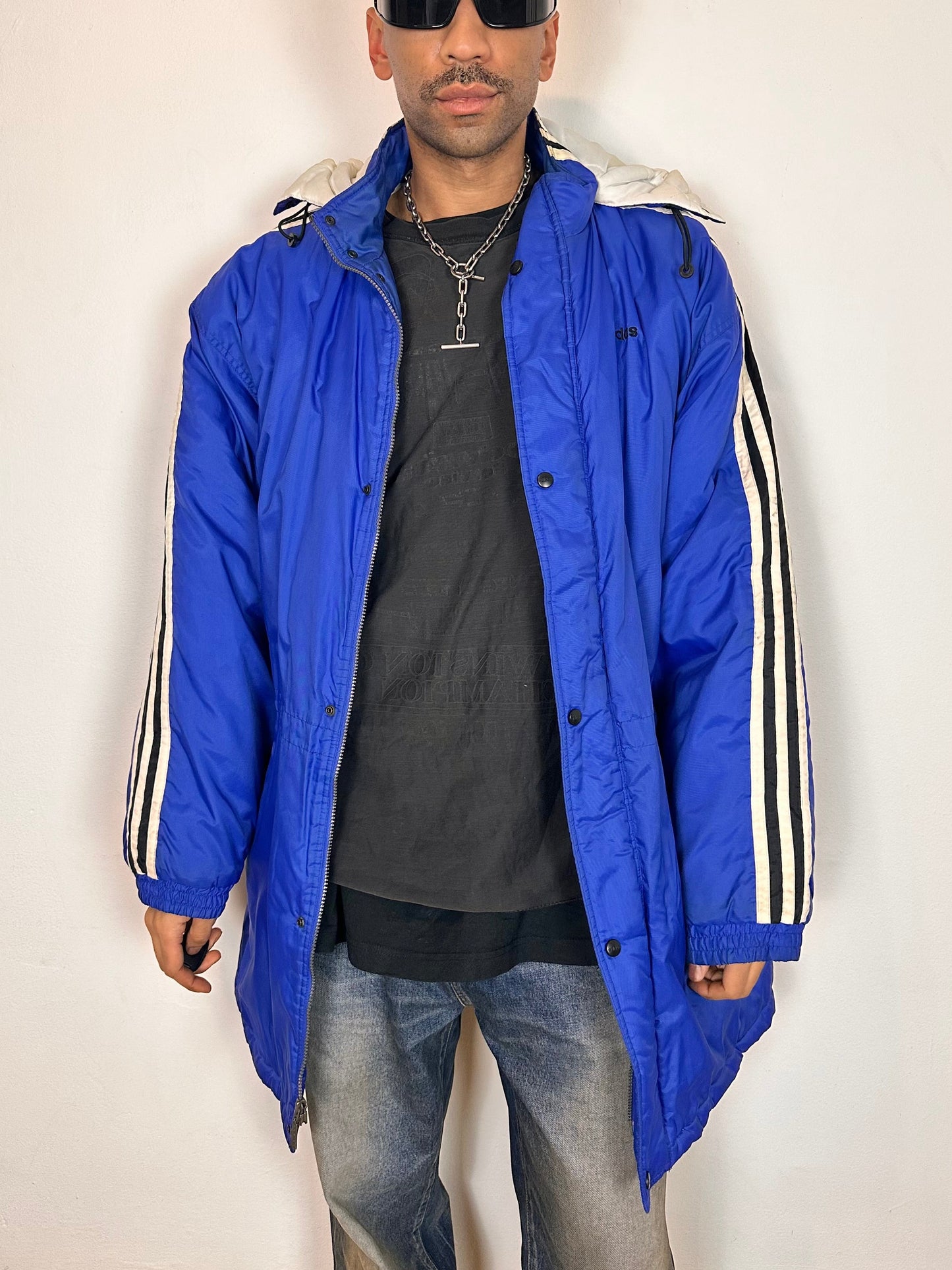 Jacket opened view of Vintage Adidas blue oversized winter puffer coat with detachable hood, white stripes, and long insulated silhouette, size XXL.