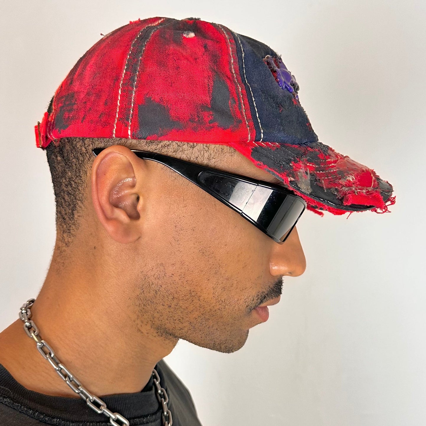Right side of Blue and red ASTROBOI* hat featuring a purple resin-coated Hawaii graphic, deconstructed visor with clear resin, and black painted accents.