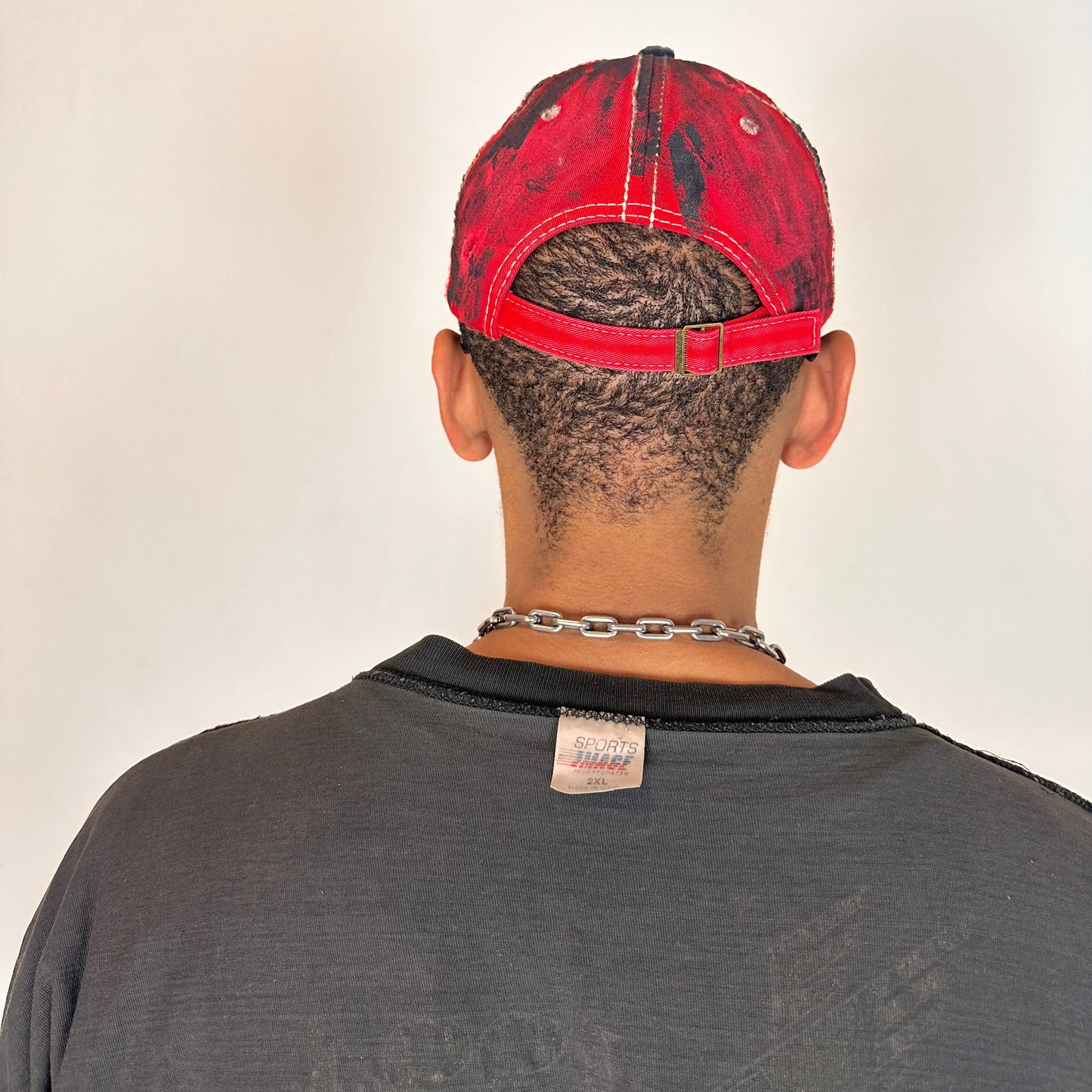 Back of of Blue and red ASTROBOI* hat featuring a purple resin-coated Hawaii graphic, deconstructed visor with clear resin, and black painted accents.