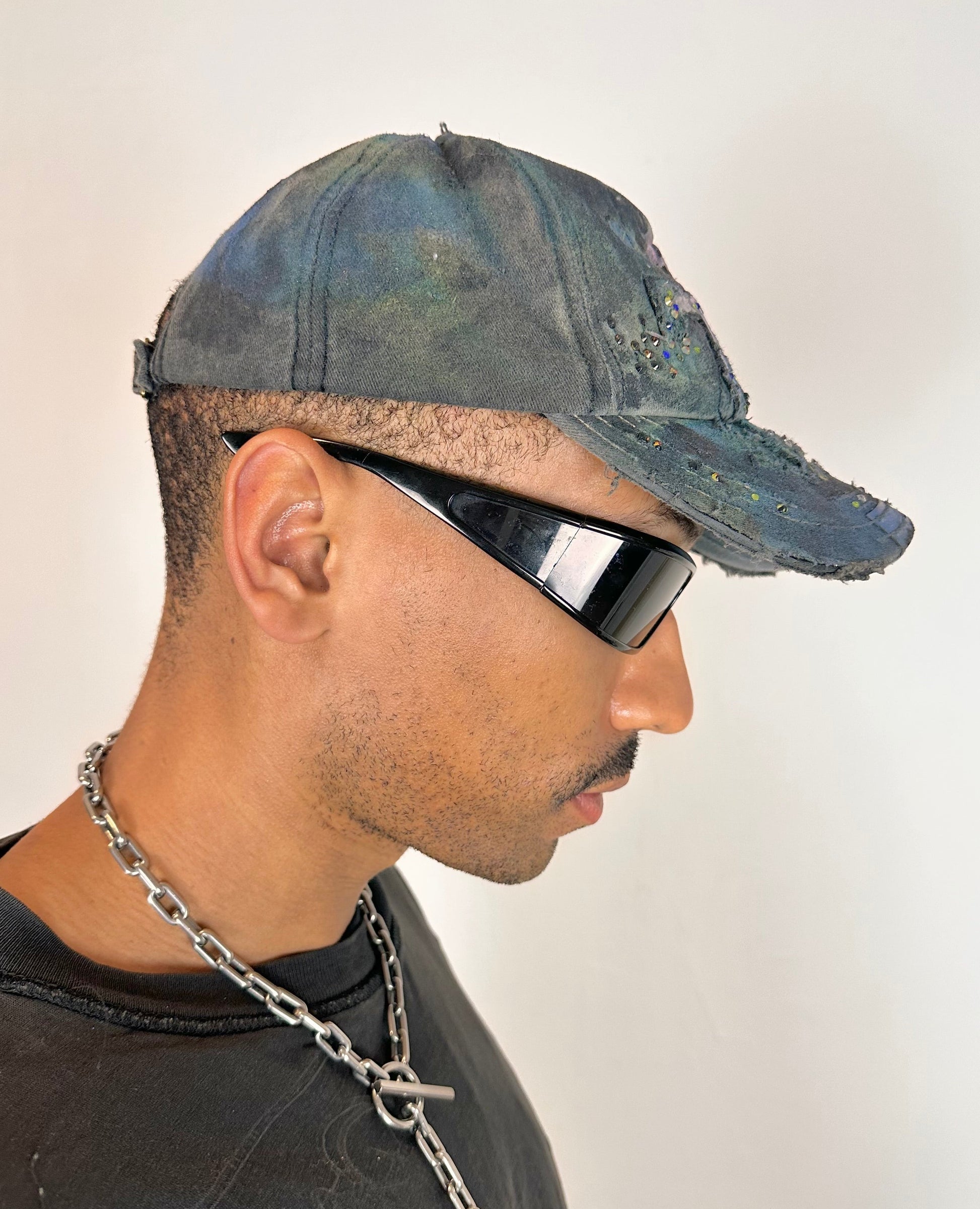 Right side of ASTROBOI* blue rainbow tropical Y2K hat with multicolored rhinestones, hand-painted shading, and adjustable strap back