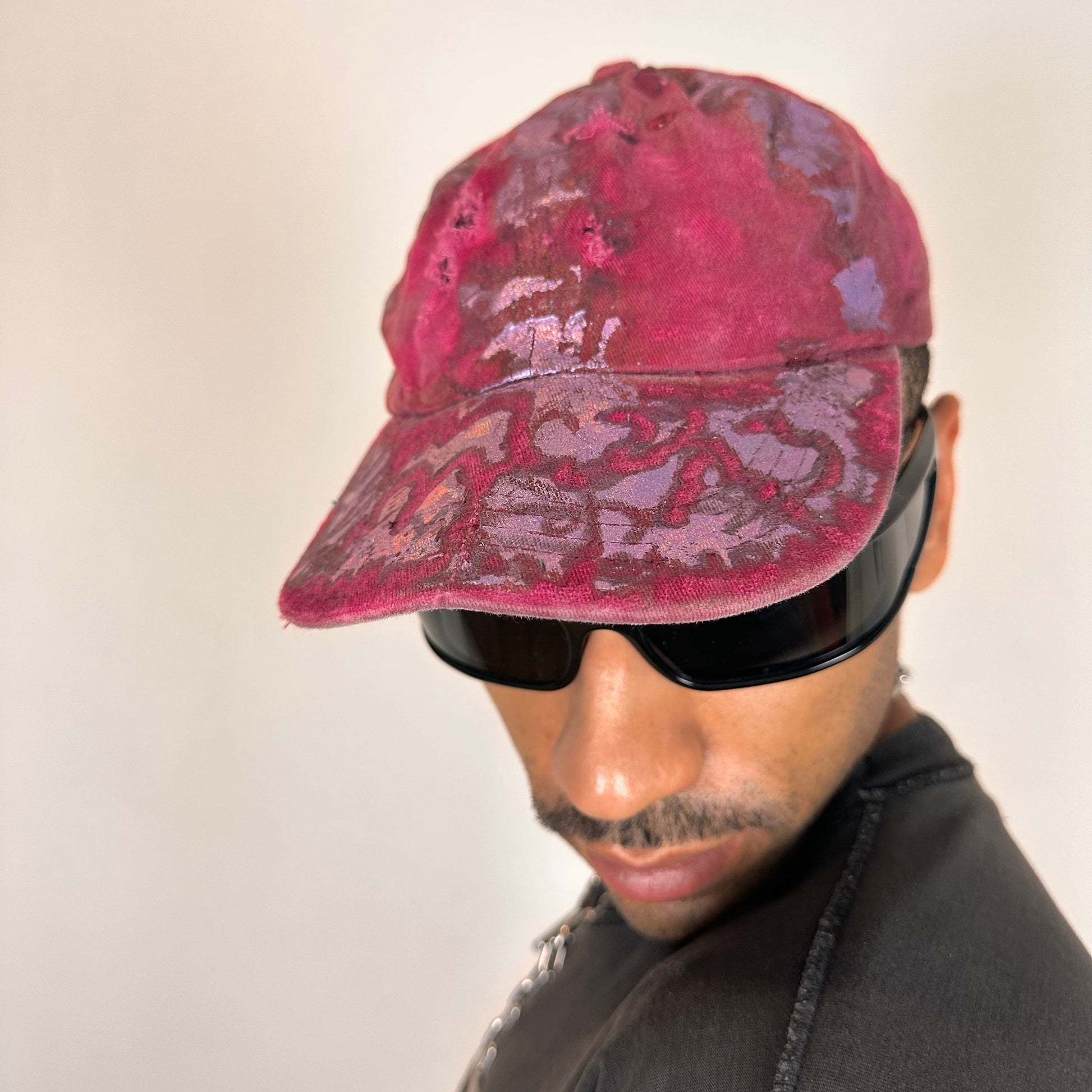ASTROBOI* MARS distressed metallic cap with lavender paint accents, bent visor, and safety pin adjustment detail.