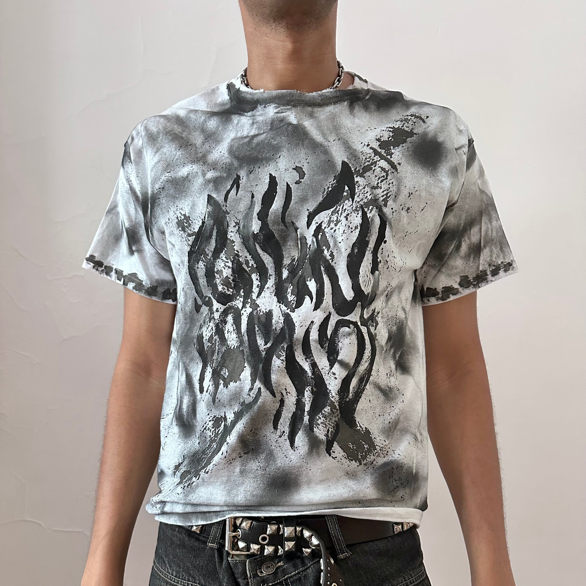 ASTROBOI* x Gildan 'Slither' white heavyweight graphic t-shirt with impressionist black flame design across the chest and black and gray hazy splatters throughout, front view.
