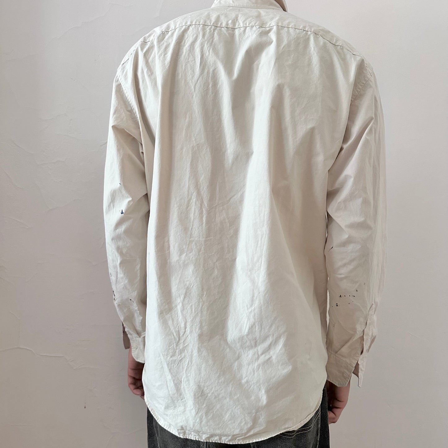 ASTROBOI* x Uniqlo 'Tattoo' tan graphic button up shirt, rear view showing pink abstract and black expressionist paint overlay, worn by male model.