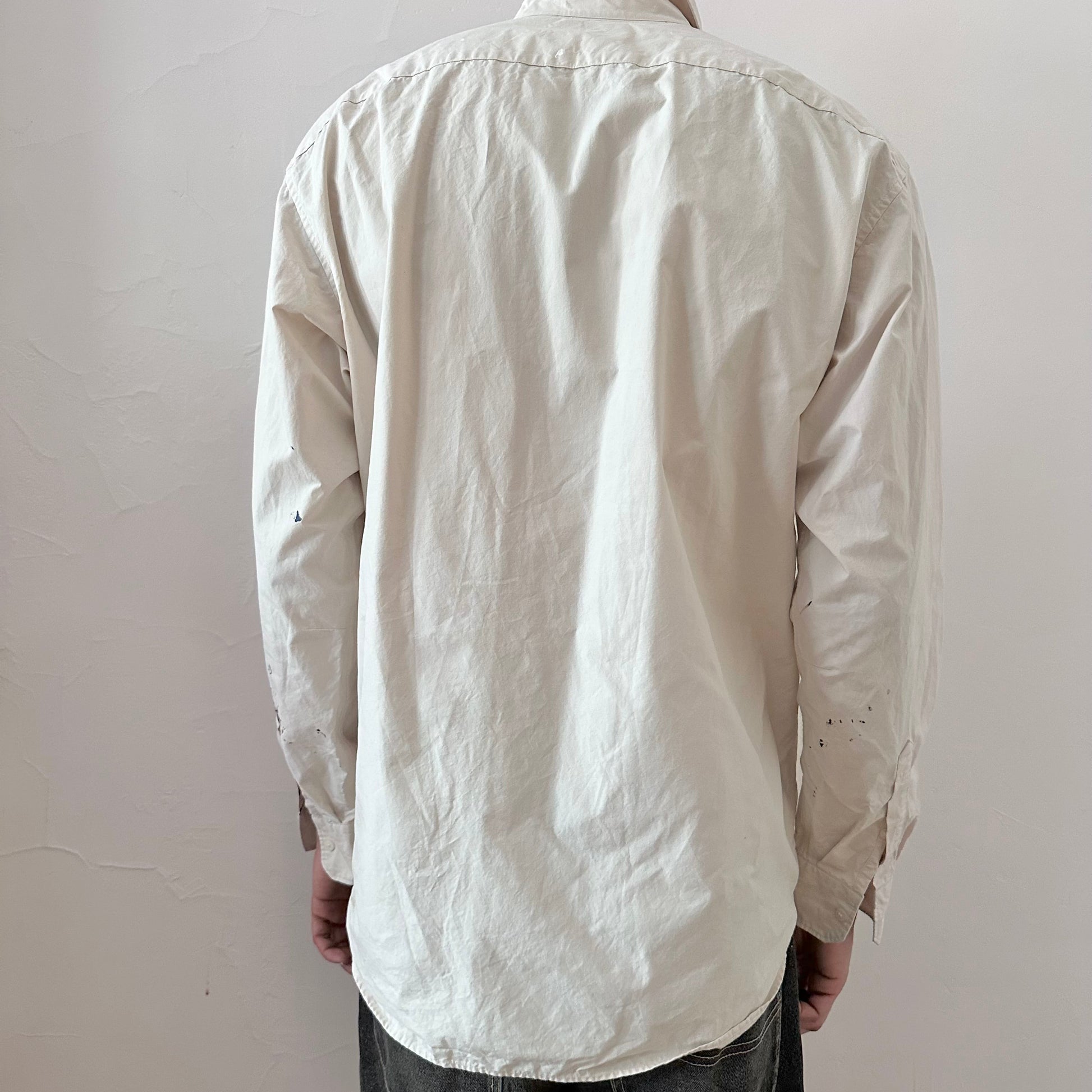 ASTROBOI* x Uniqlo 'Tattoo' tan graphic button up shirt, rear view showing pink abstract and black expressionist paint overlay, worn by male model.