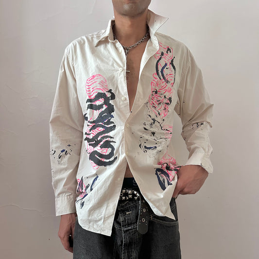 ASTROBOI* x Uniqlo 'Tattoo' tan relaxed-fit graphic button up shirt with hand-painted pink abstract design and black expressionist pattern overlay, front view.