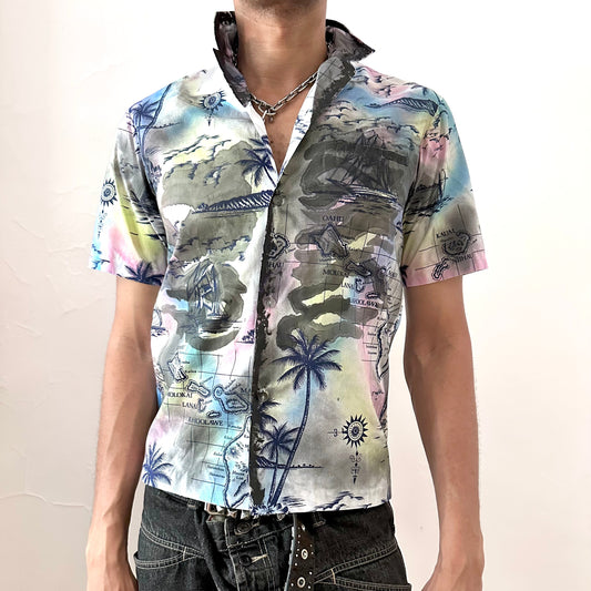 ASTROBOI* 'Sulfur Surfer' white boxy-fit tropical short sleeve button up shirt with custom navy Hawaiian iconography paint treatment throughout and chest pocket at right, front view.