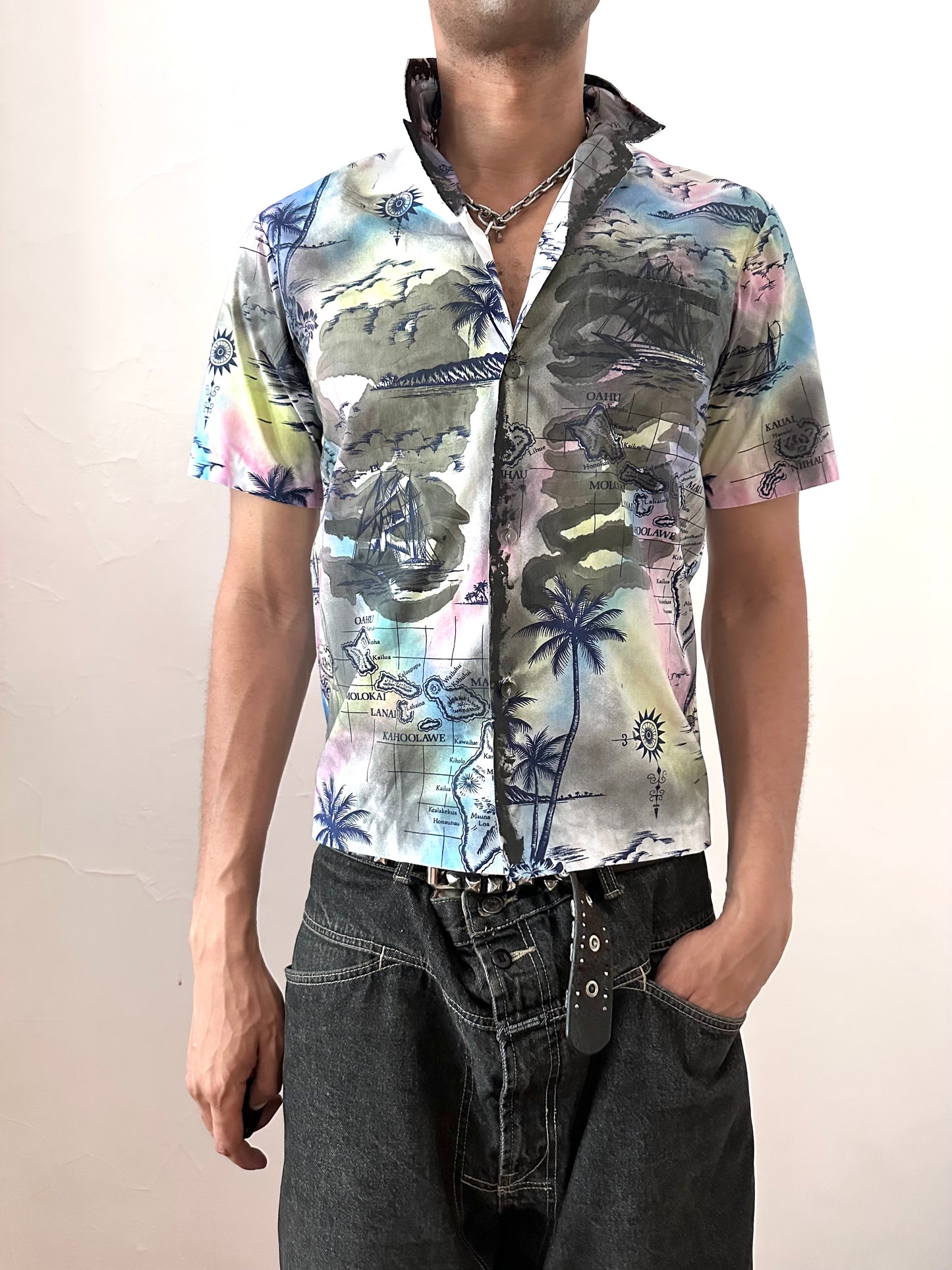 Male model wearing ASTROBOI* 'Sulfur Surfer' white tropical graphic button up shirt, styled full look, ASTROBOI* STUDIO NYC.