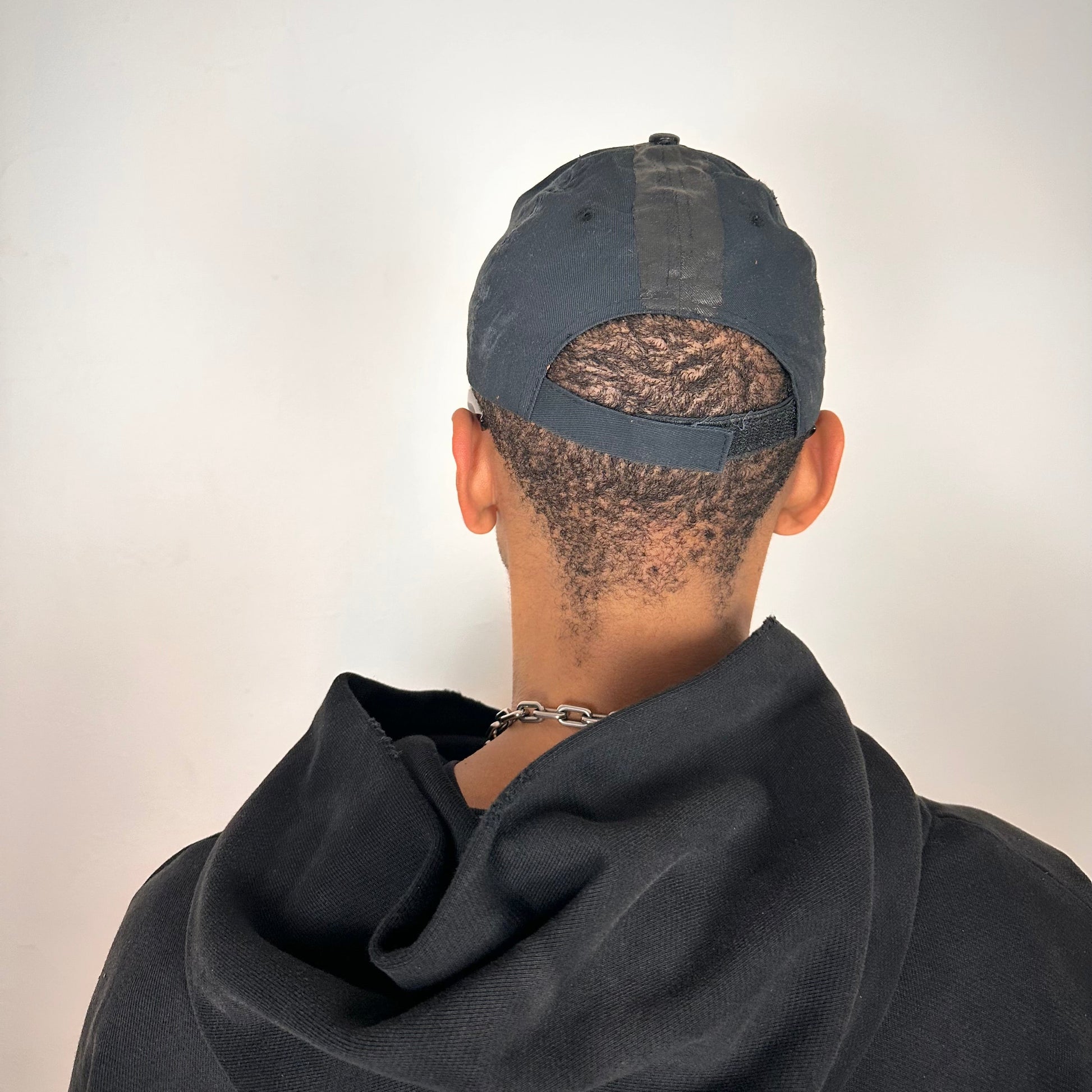 Back side of ASTROBOI* RBP navy and black distressed utility hat with deconstructed visor, rhinestone logo sealed in resin, adjustable strap, custom NYC piece