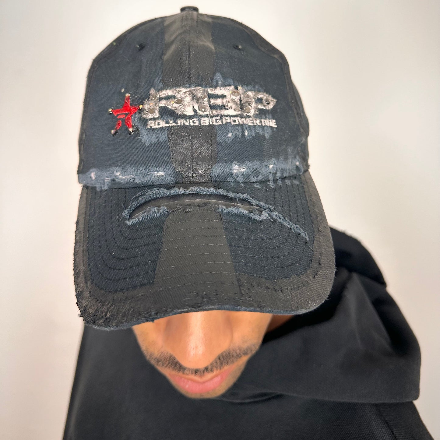 Cover image of ASTROBOI* RBP navy and black distressed utility hat with deconstructed visor, rhinestone logo sealed in resin, adjustable strap, custom NYC piece