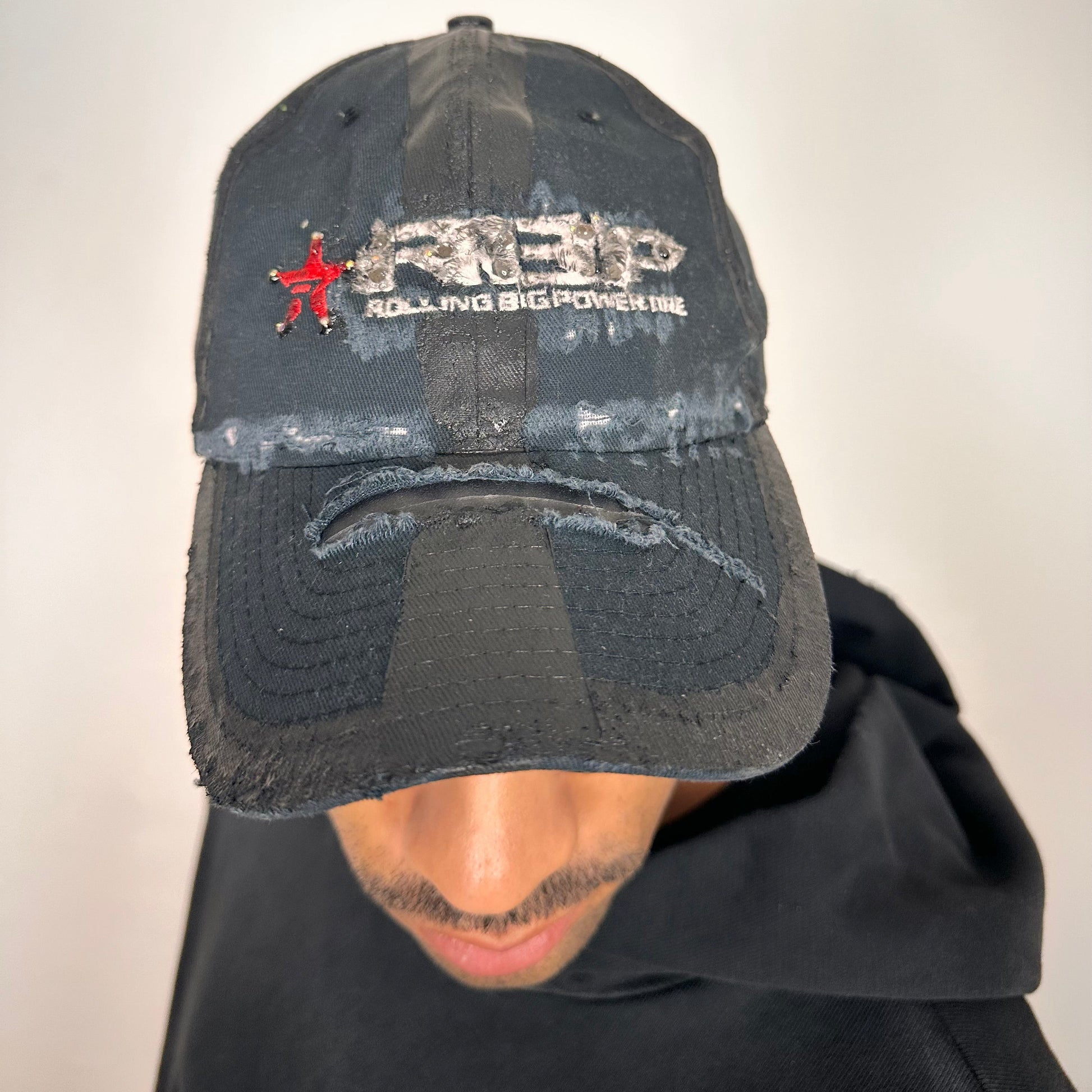 Cover image of ASTROBOI* RBP navy and black distressed utility hat with deconstructed visor, rhinestone logo sealed in resin, adjustable strap, custom NYC piece