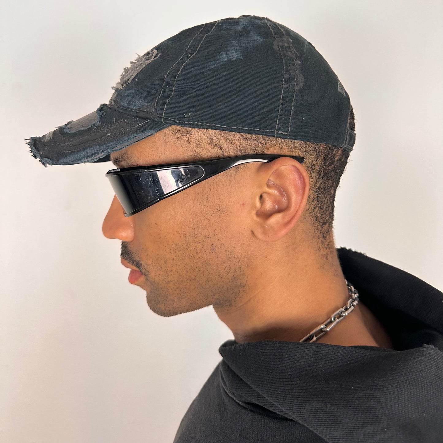 Left side of ASTROBOI* New York Aquarium navy distressed baseball hat with resin-sealed rhinestone logo, black waxed paint details, adjustable strap, custom NYC piece