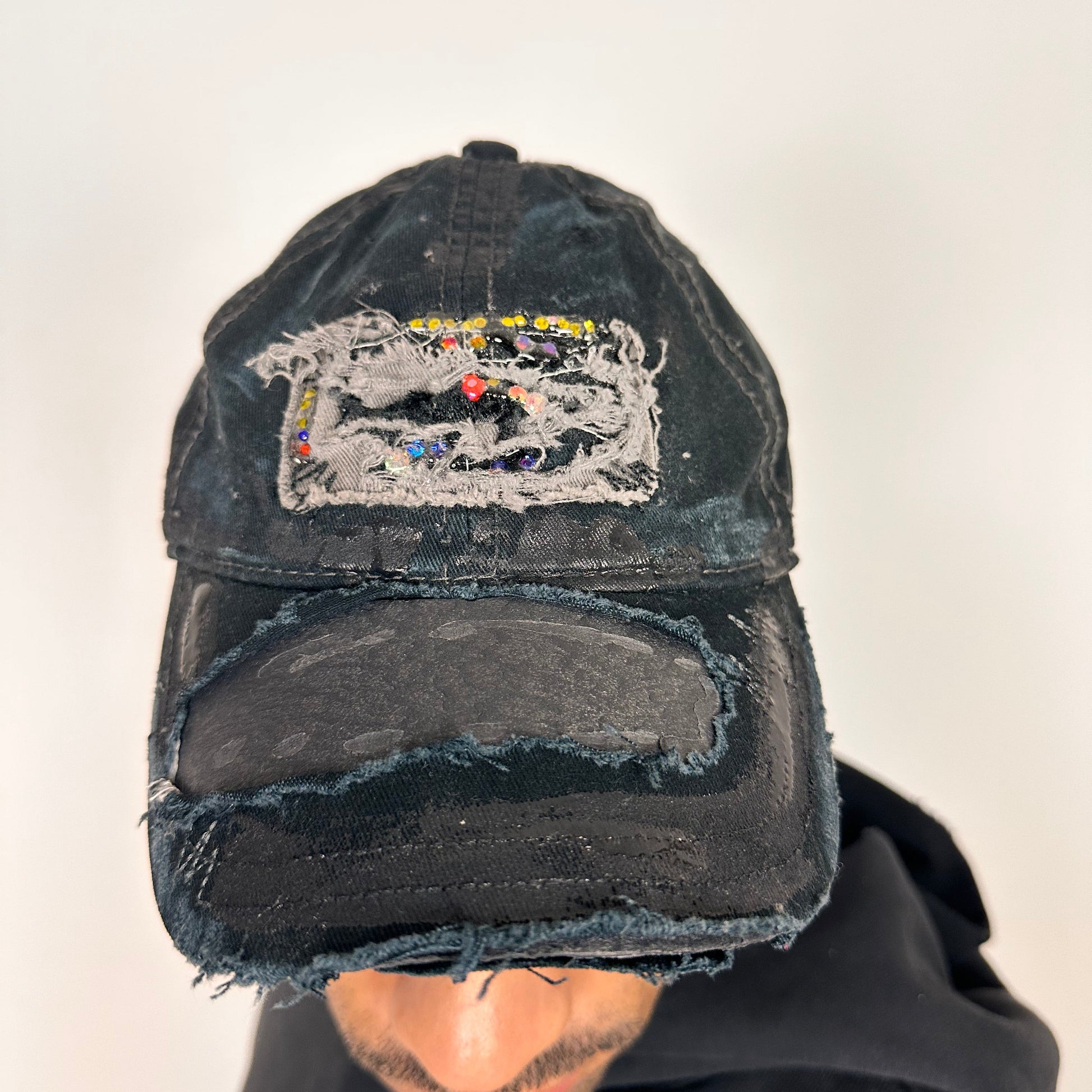 Front of ASTROBOI* New York Aquarium navy distressed baseball hat with resin-sealed rhinestone logo, black waxed paint details, adjustable strap, custom NYC piece