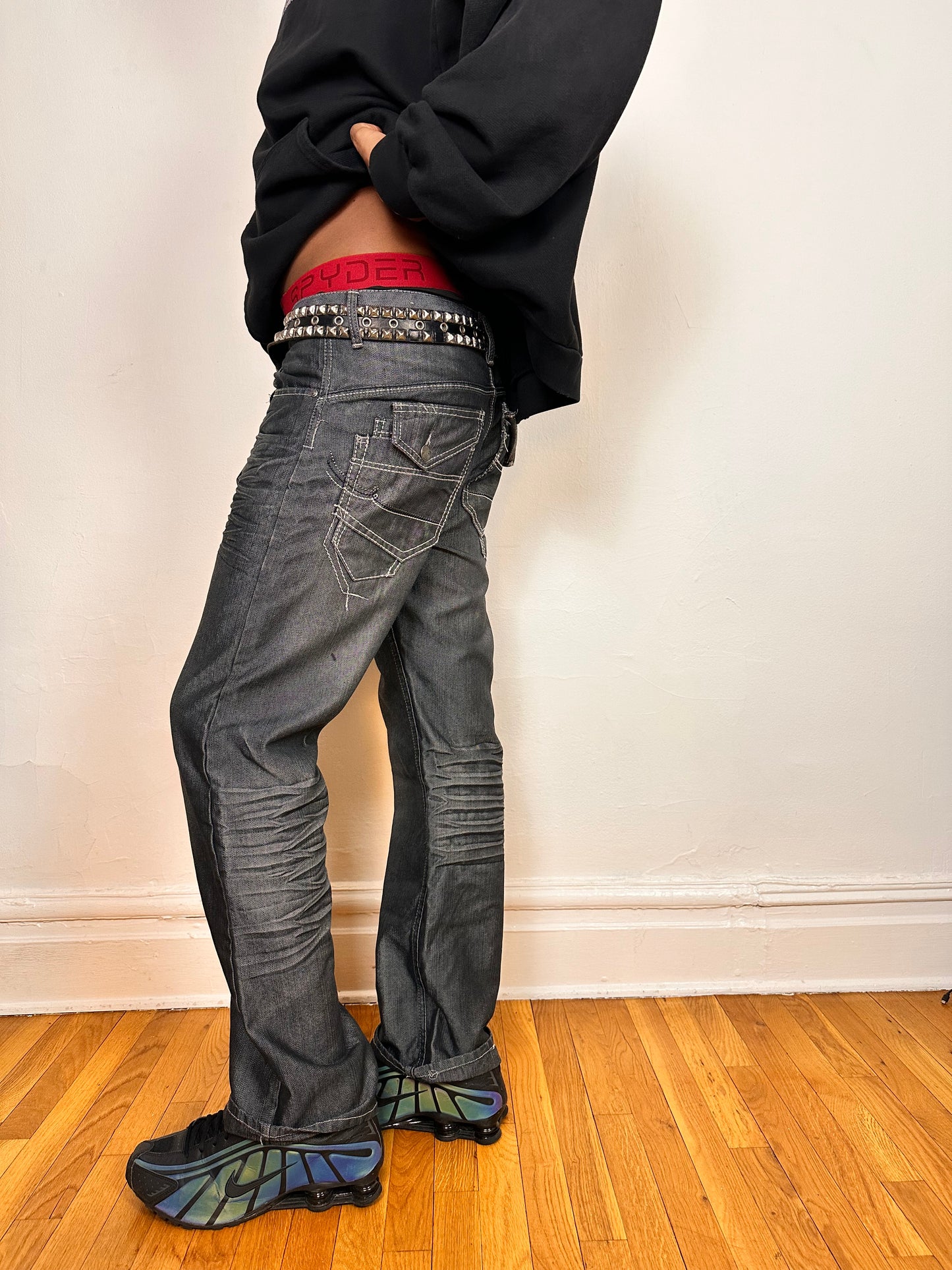 Left side of Vintage Y2K Champs silver and black chambray jeans, relaxed fit with whiskering and flap back pockets, size 32x34