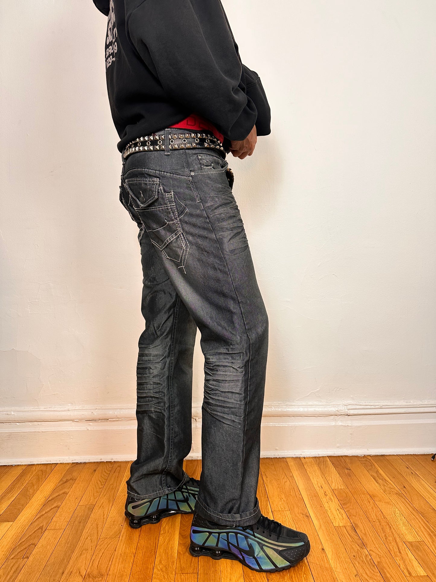 Right side of Vintage Y2K Champs silver and black chambray jeans, relaxed fit with whiskering and flap back pockets, size 32x34