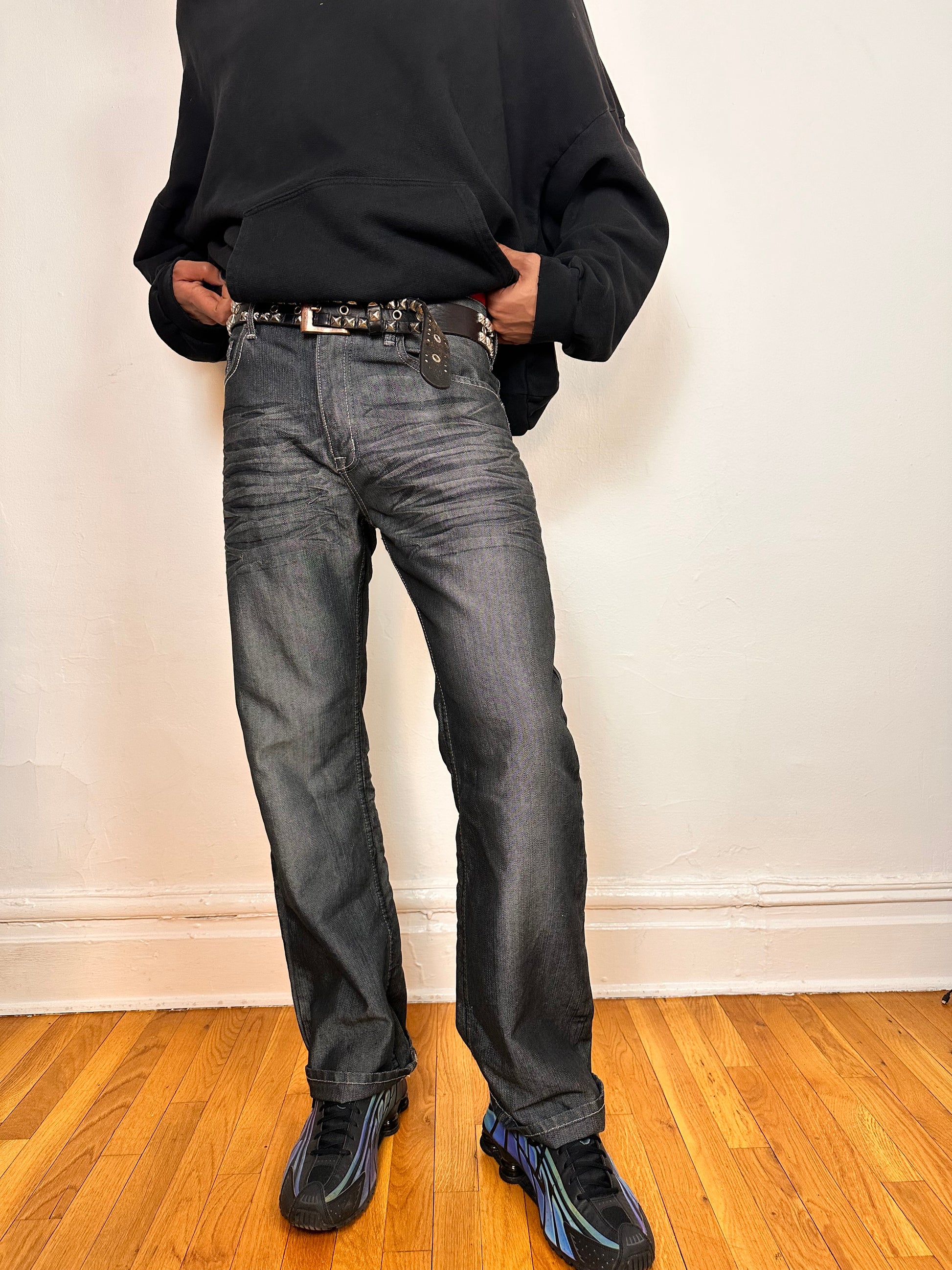 Front of Vintage Y2K Champs silver and black chambray jeans, relaxed fit with whiskering and flap back pockets, size 32x34