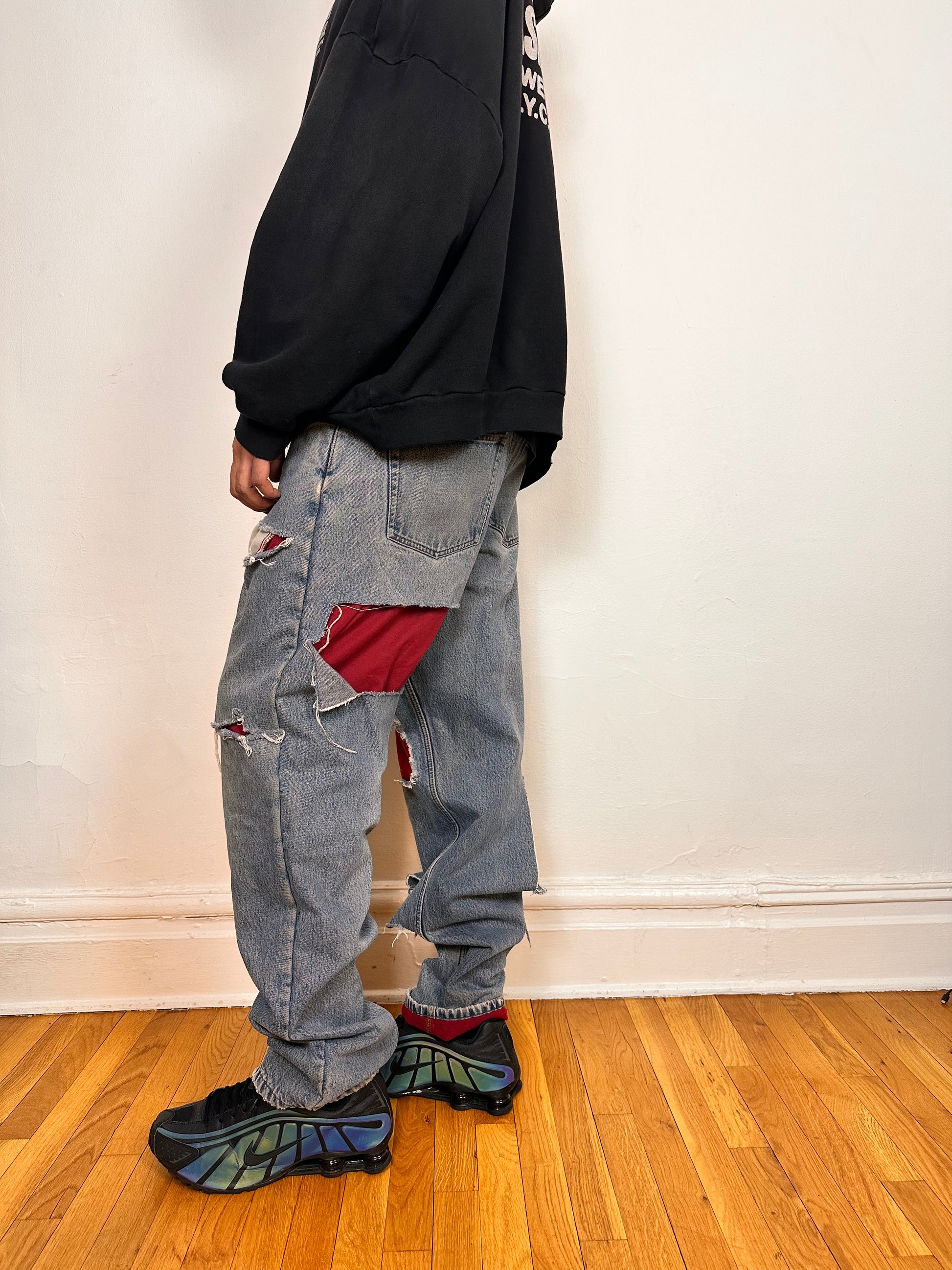 Left side of ASTROBOI* Eddie Bauer mid blue baggy jeans, 38x36, ripped with flannel lining, relaxed fit, customized in NYC