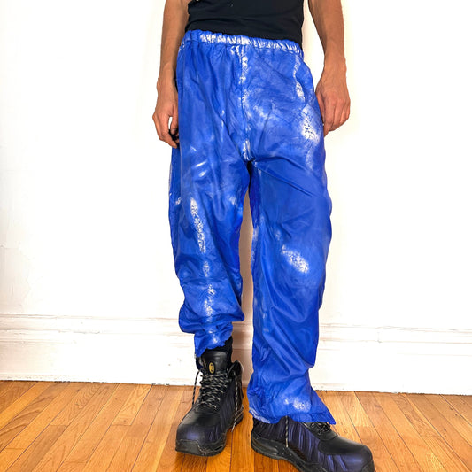 Cover shot of ASTROBOI* 'Cloudy Sky' blue nylon sweatpants, XL, baggy fit, drawstring waistband, side zippers, lined for warmth, handcrafted in NYC
