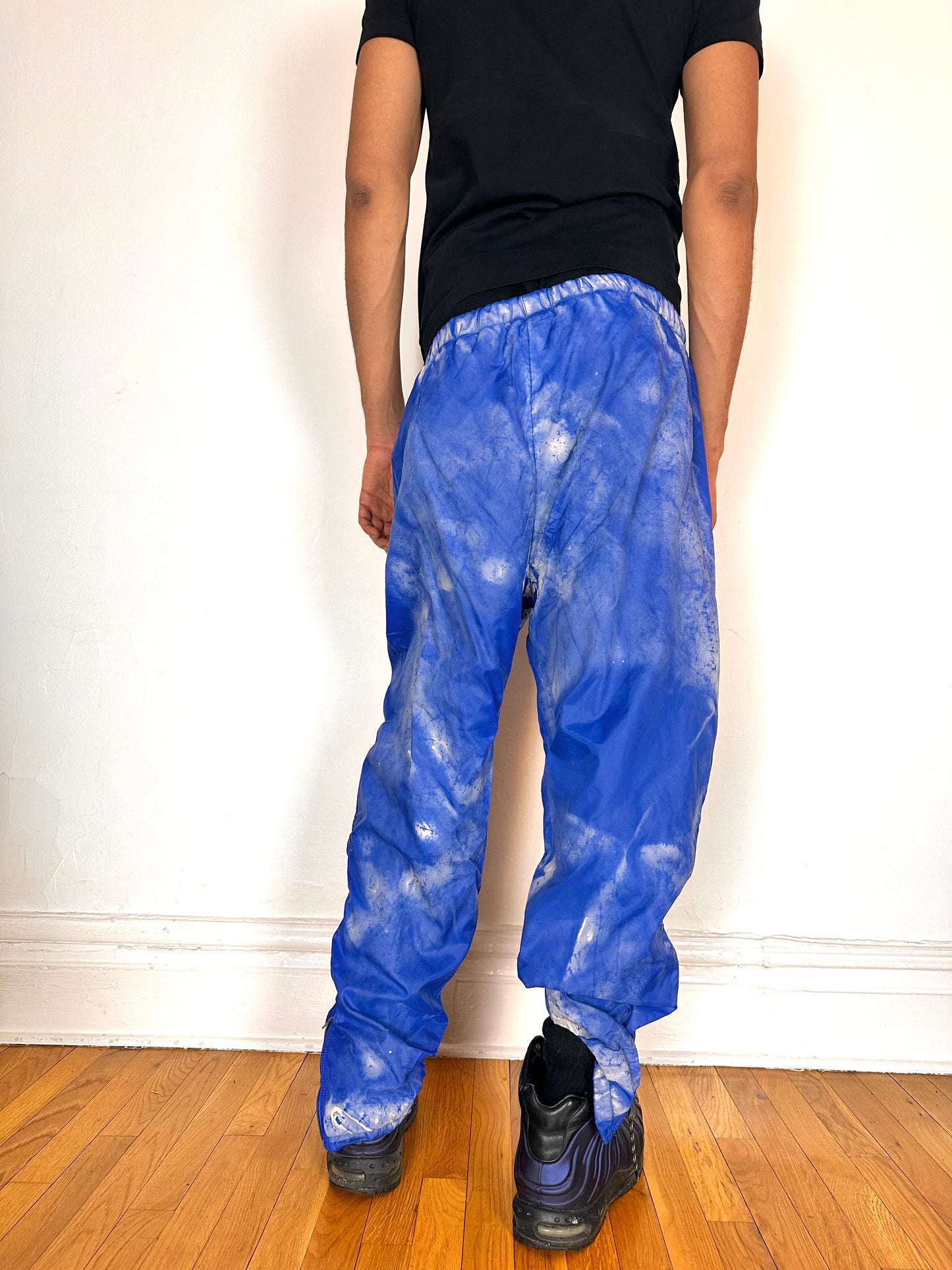 Back side of ASTROBOI* 'Cloudy Sky' blue nylon sweatpants, XL, baggy fit, drawstring waistband, side zippers, lined for warmth, handcrafted in NYC