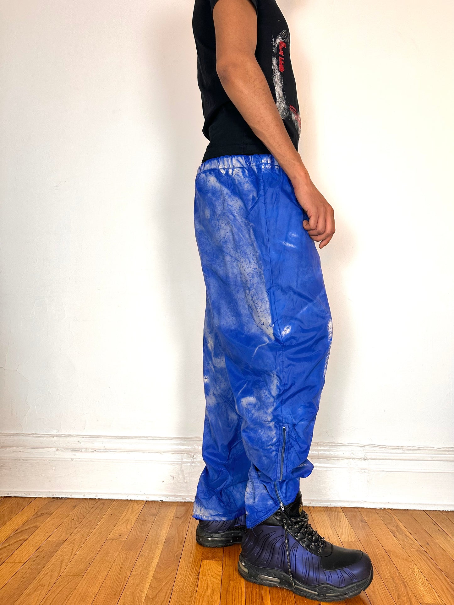 Right side of ASTROBOI* 'Cloudy Sky' blue nylon sweatpants, XL, baggy fit, drawstring waistband, side zippers, lined for warmth, handcrafted in NYC