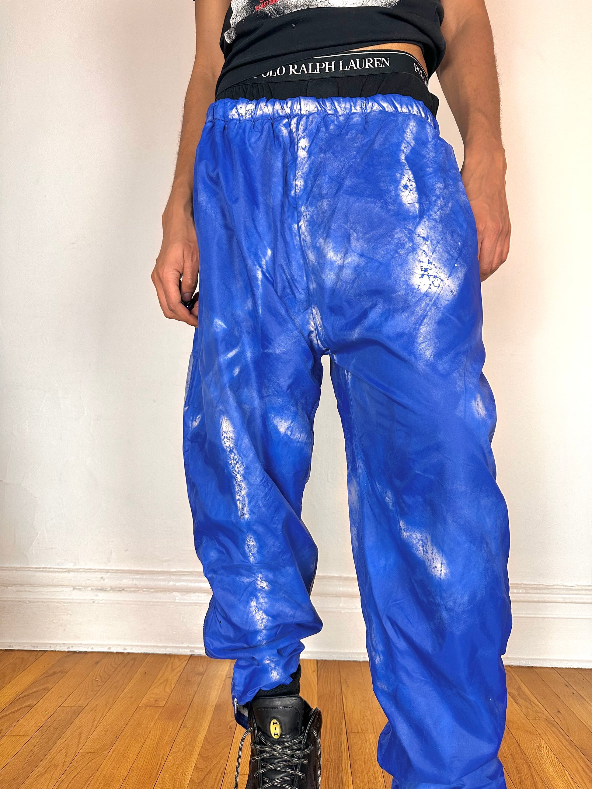 Close up of ASTROBOI* 'Cloudy Sky' blue nylon sweatpants, XL, baggy fit, drawstring waistband, side zippers, lined for warmth, handcrafted in NYC