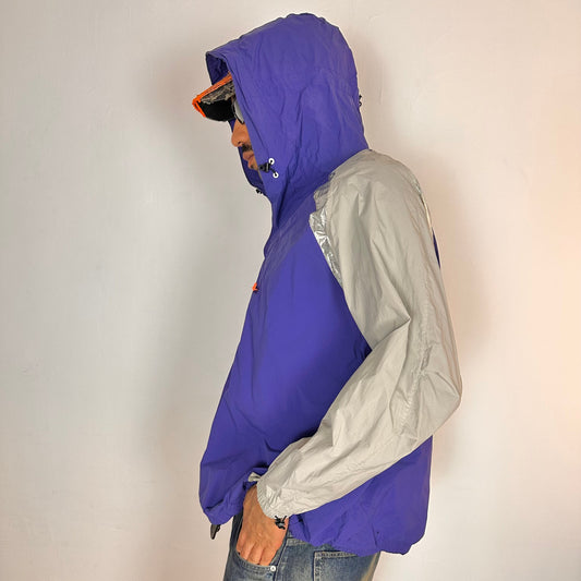 Left side of ADIDAS x KOLOR purple and silver futuristic anorak windbreaker jacket with foil shoulder detailing, mesh ventilation panel, and boxy fit