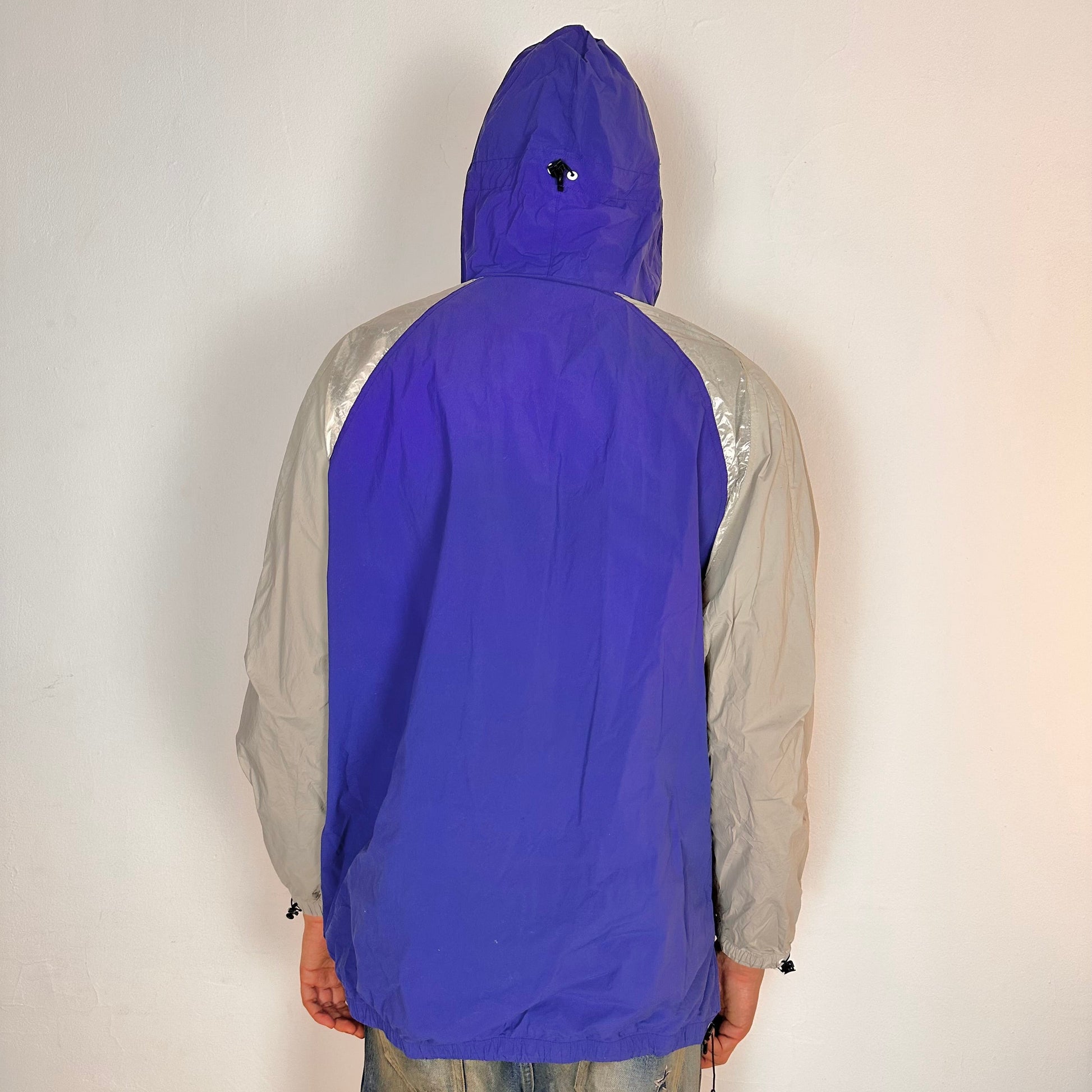 Back of ADIDAS x KOLOR purple and silver futuristic anorak windbreaker jacket with foil shoulder detailing, mesh ventilation panel, and boxy fit