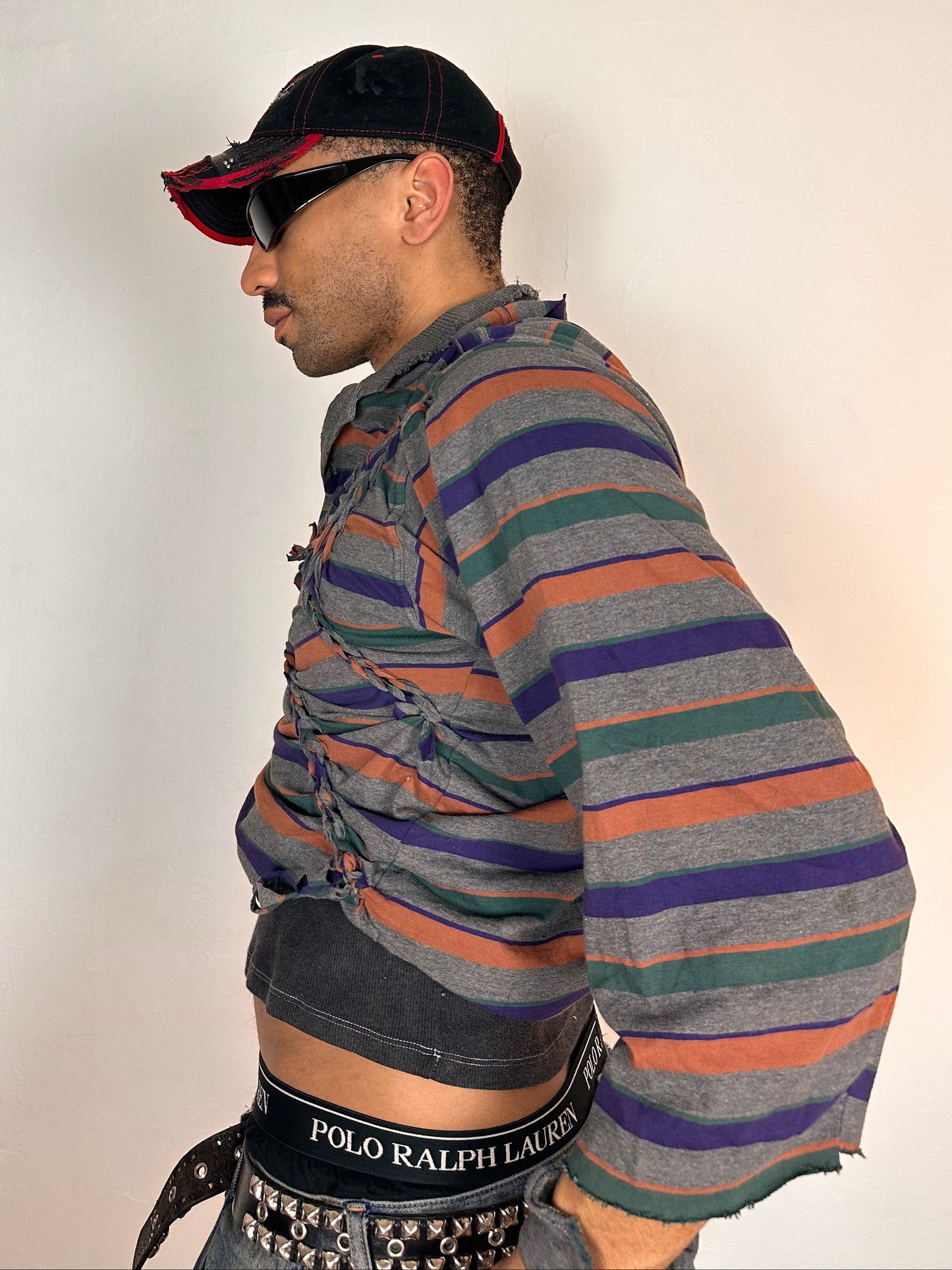 Left side of ASTROBOI* Oren grey striped braided twist long sleeve polo top with deconstructed sleeves and loose fit, size Medium