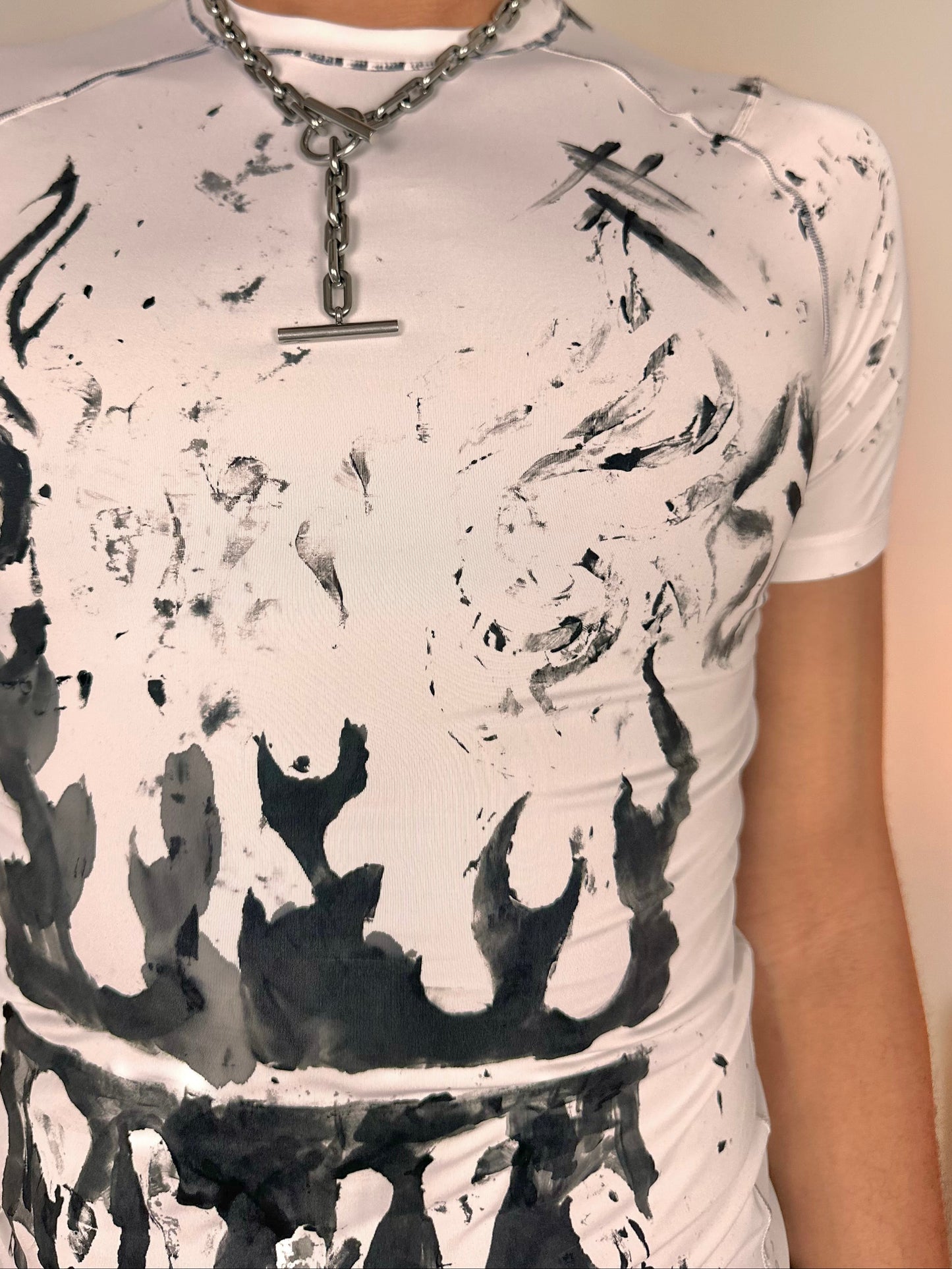 Close up of ASTROBOI* Flames white and black tattoo print compression top with stretch fabric and tight fit, hand-painted design, size Medium