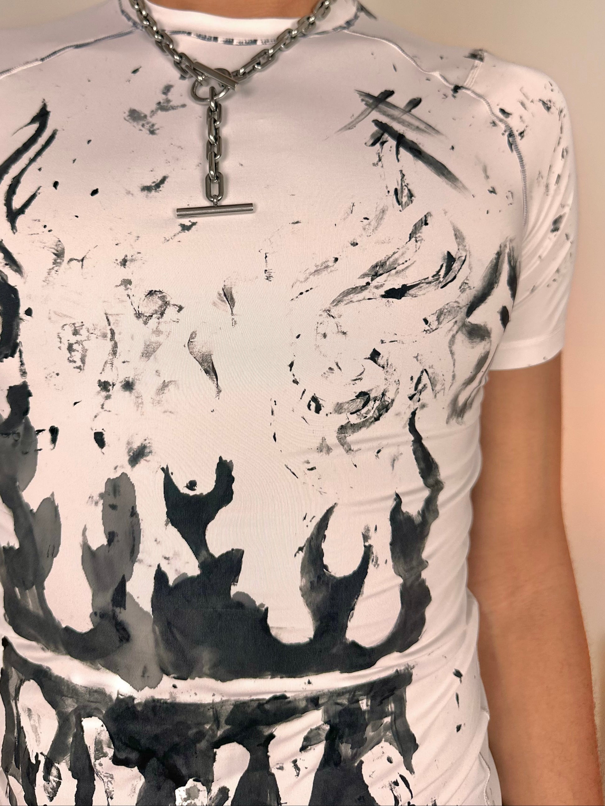 Close up of ASTROBOI* Flames white and black tattoo print compression top with stretch fabric and tight fit, hand-painted design, size Medium