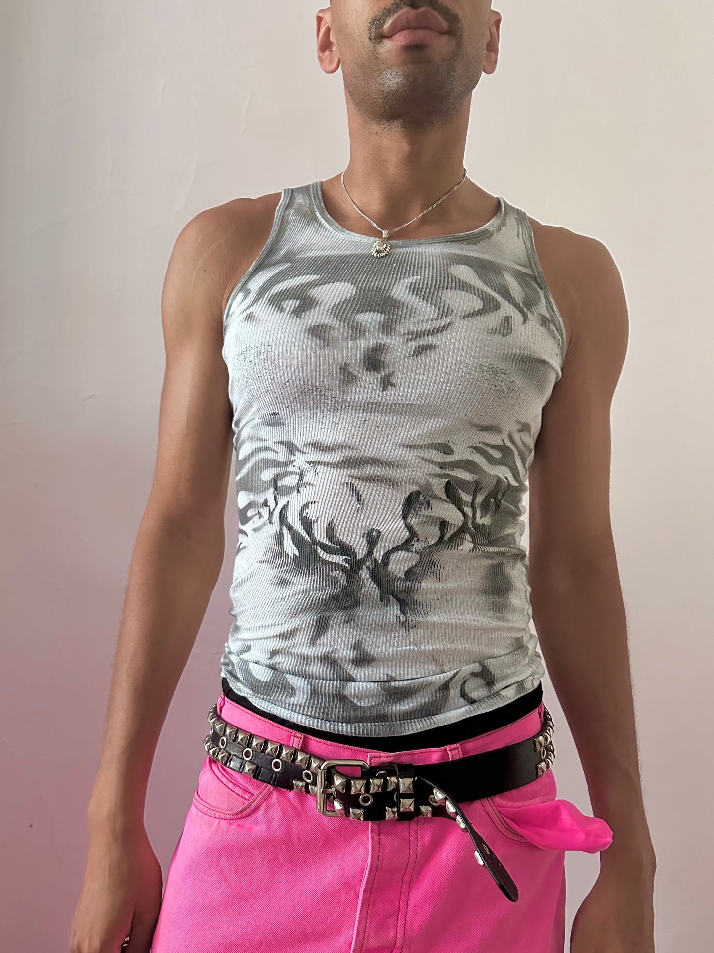 Male model wearing ASTROBOI* x Gildan 'Black Fire' Y2K flame print tank top, styled full look, ASTROBOI* STUDIO NYC.
