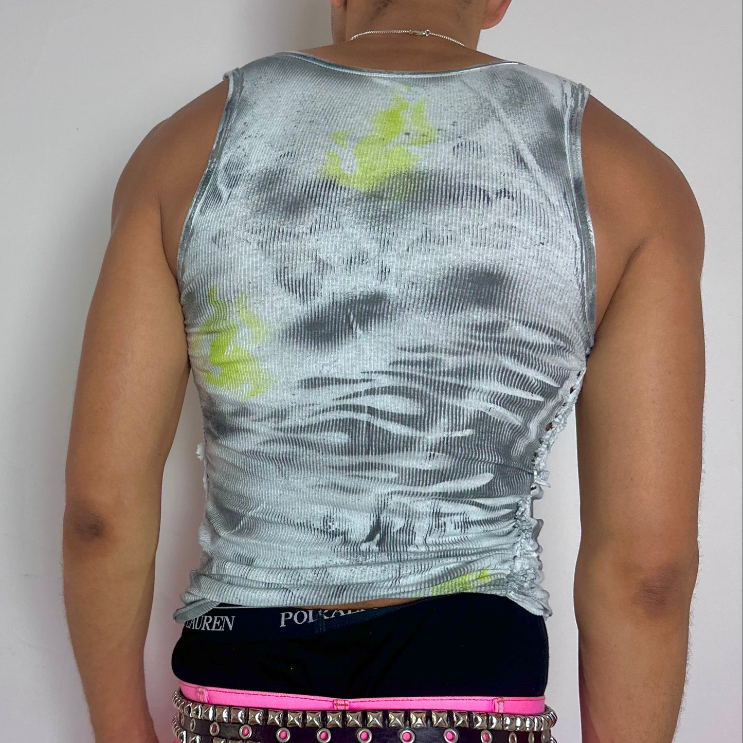 ASTROBOI* x Gildan 'Neon Flame' Y2K flame print braided tank top, rear view showing ultraviolet splatter and flame print detail, worn by male model.