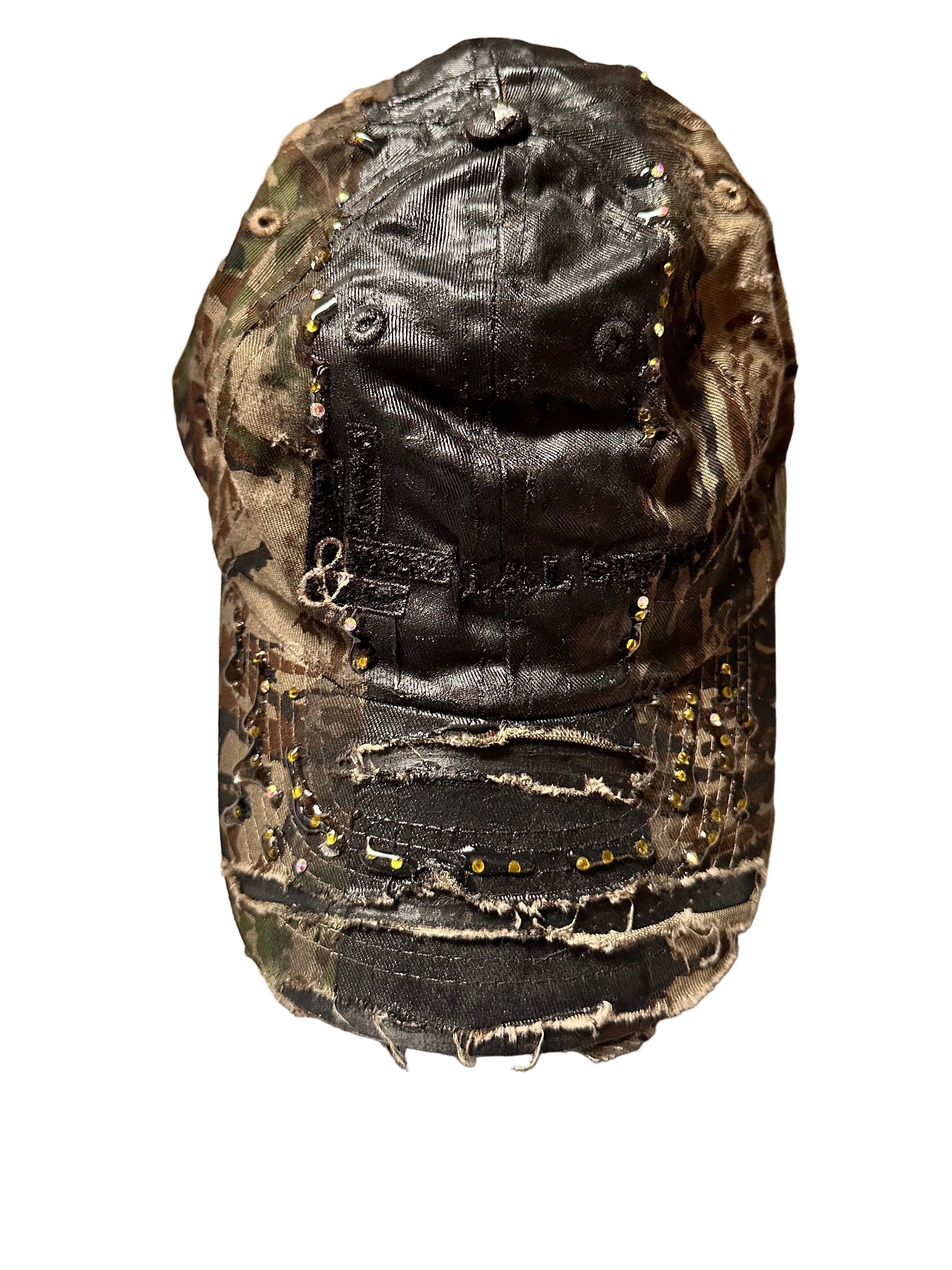 Product shot of ASTROBOI* L&L Supply green RealTree camo utility hat with purple and green rhinestones sealed in resin and black tattoo print detailing