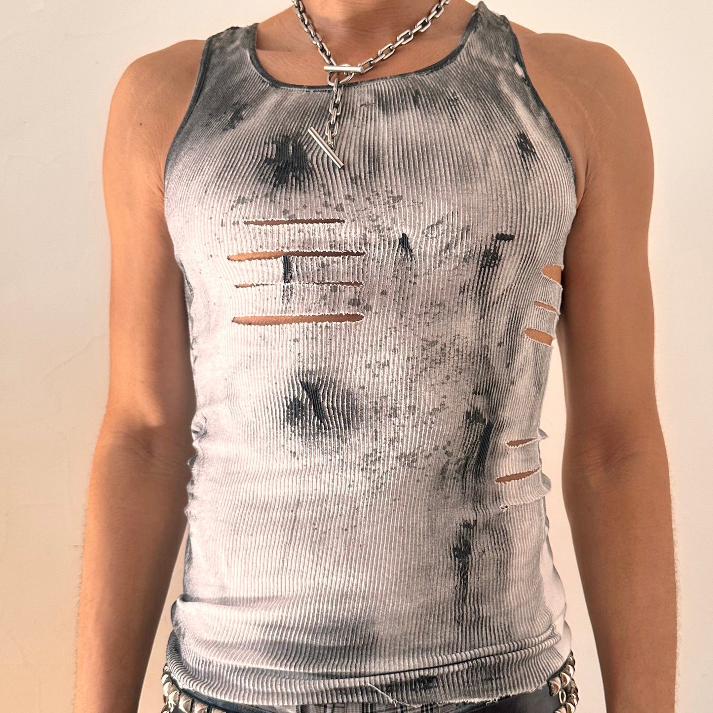 Close up of ASTROBOI* x Hanes 'Hero' white ribbed cotton tank top with hand-painted black abstract graphic print and deconstructed cut-outs along chest and sides, customized at ASTROBOI* STUDIO in NYC.