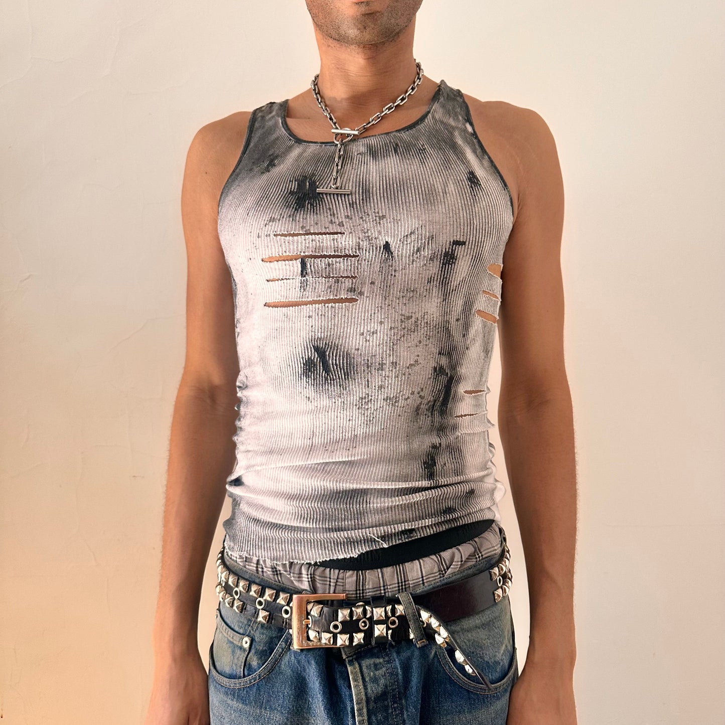 Front of ASTROBOI* x Hanes 'Hero' white ribbed cotton tank top with hand-painted black abstract graphic print and deconstructed cut-outs along chest and sides, customized at ASTROBOI* STUDIO in NYC.