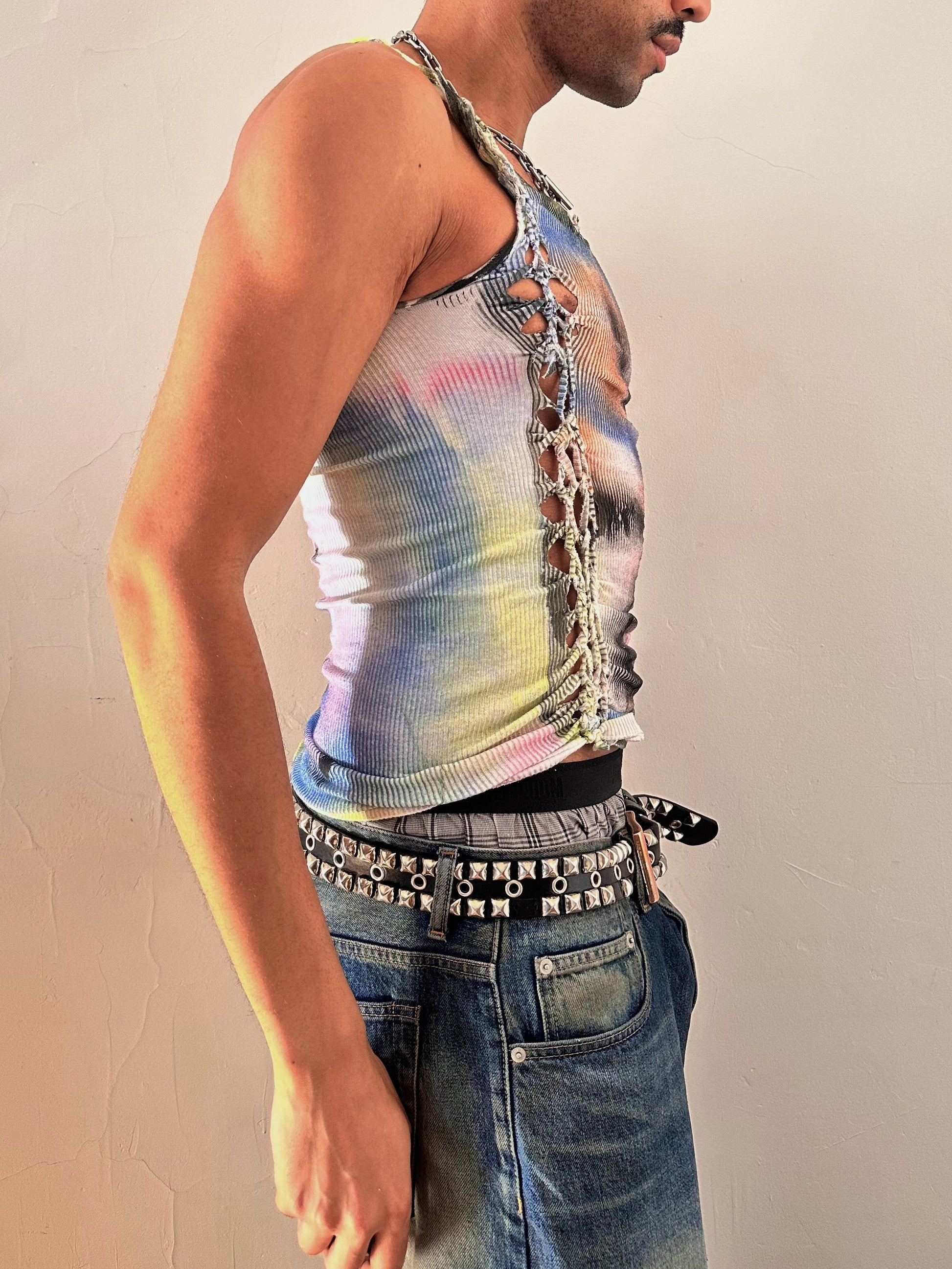 Right side of of ASTROBOI* ‘Sunset’ white braided twist tank top with slashed detailing and a form-fitting silhouette. Handmade custom piece from ASTROBOI* STUDIO in NYC.