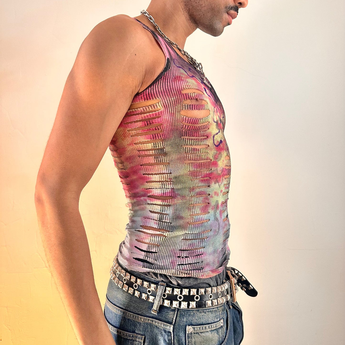 Close-up of ASTROBOI* x Hanes 'Skies' tank top showing abstract purple wavy chest graphic and hand-painted tie dye detail, right side view.