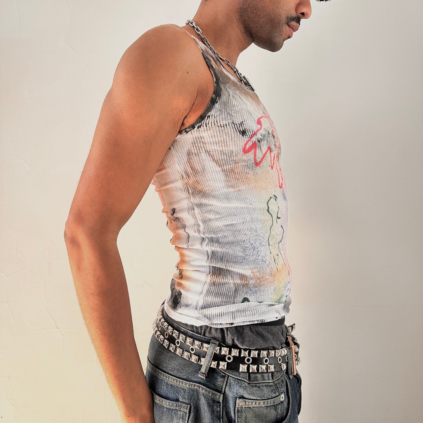 Right side detail of ASTROBOI* x Hanes 'HEAVEN' showing hand-painted rainbow haze and graffiti print on ribbed cotton fabric.