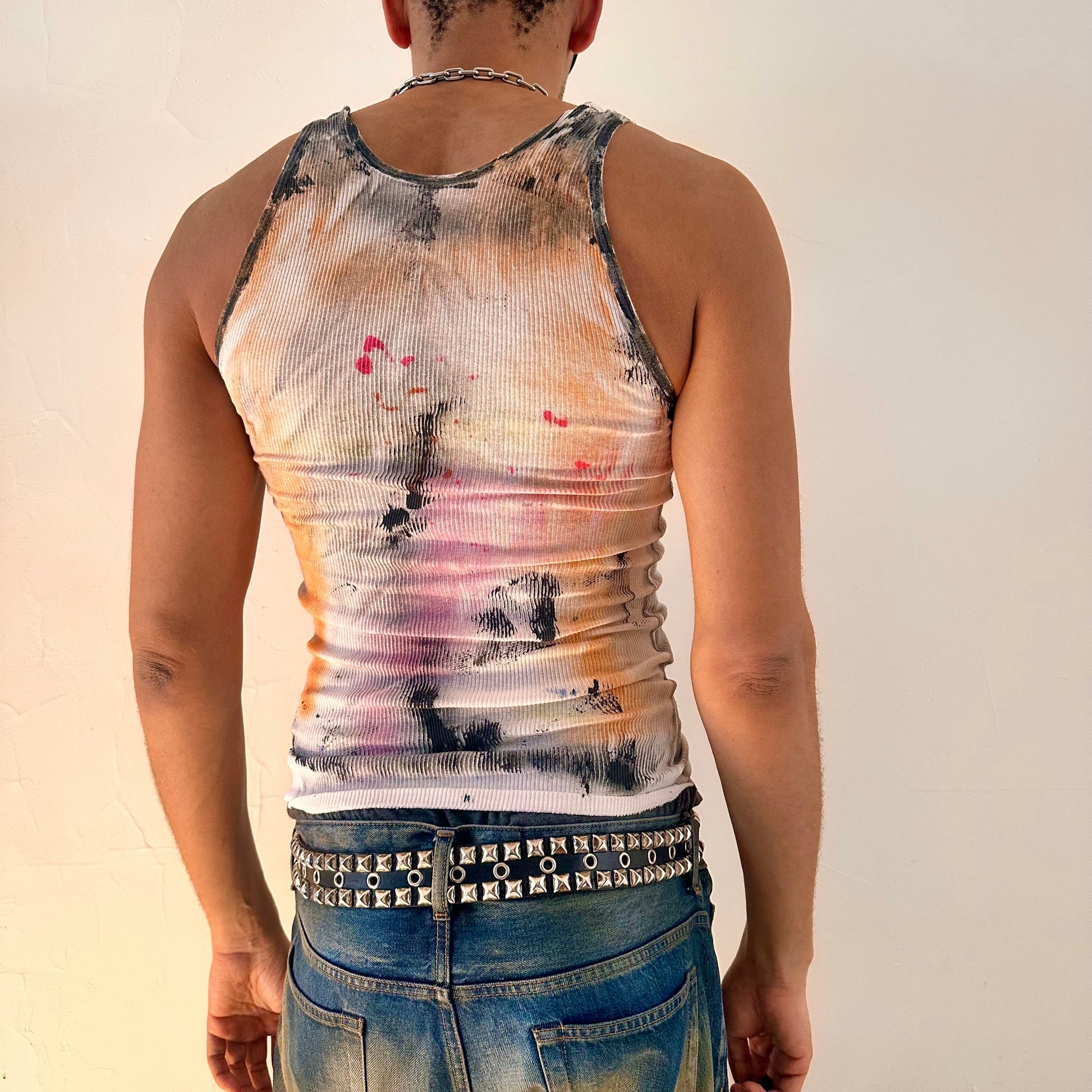 ASTROBOI* x Hanes 'HEAVEN' white ribbed graffiti tank top, rear view showing hand-painted rainbow and graffiti design, worn by male model.