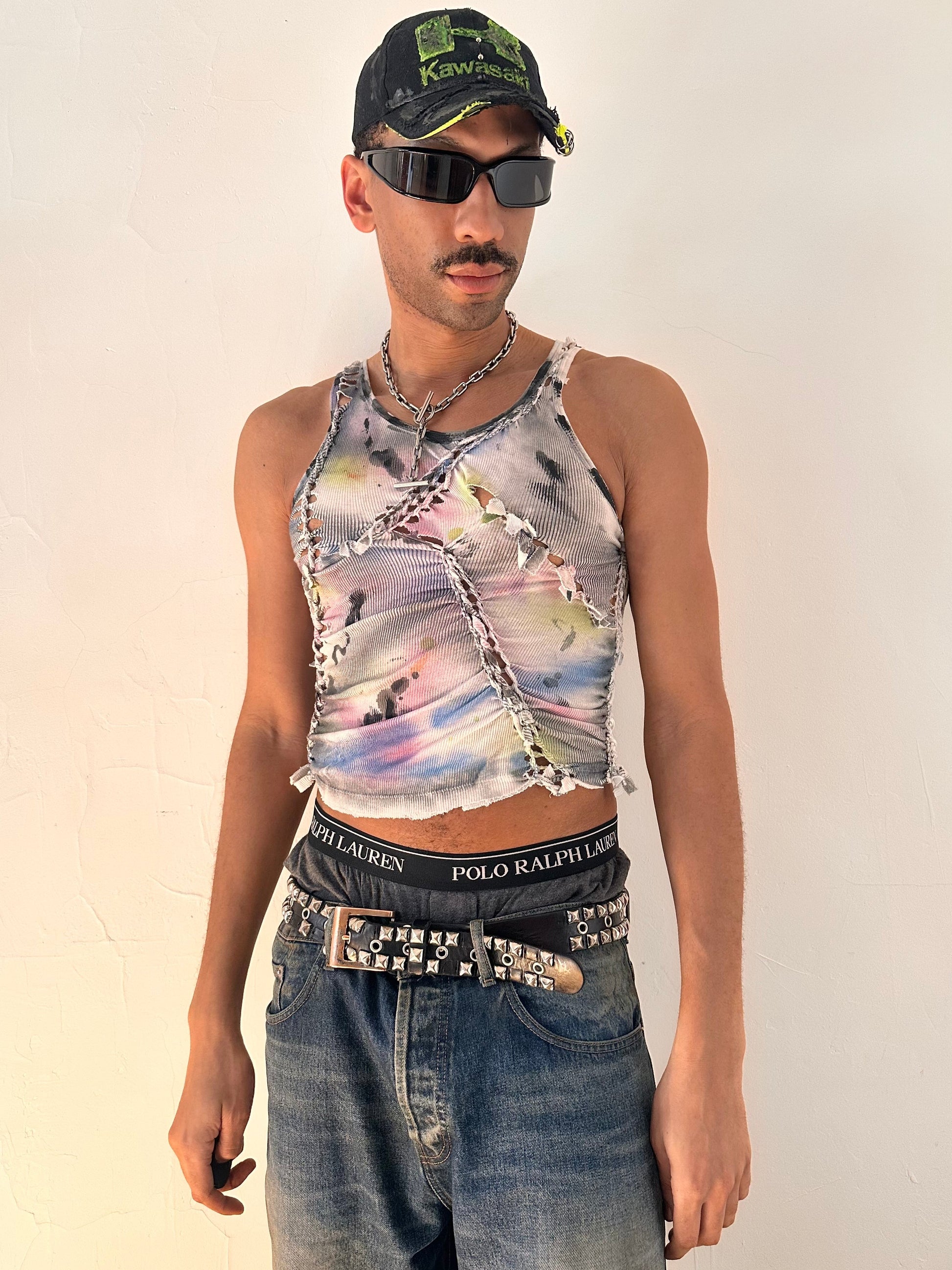 Male model wearing ASTROBOI* x Calvin Klein 'Tri Color' white braided twist tank top with rainbow watercolor design, styled full look, ASTROBOI* STUDIO NYC.