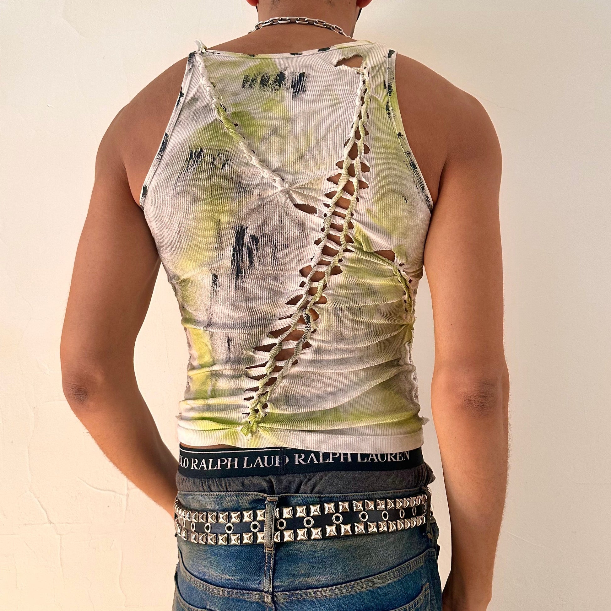 ASTROBOI* x Calvin Klein 'Brat' white braided twist tank top, rear view showing braid, slash, raw hem and paint detail, worn by male model.