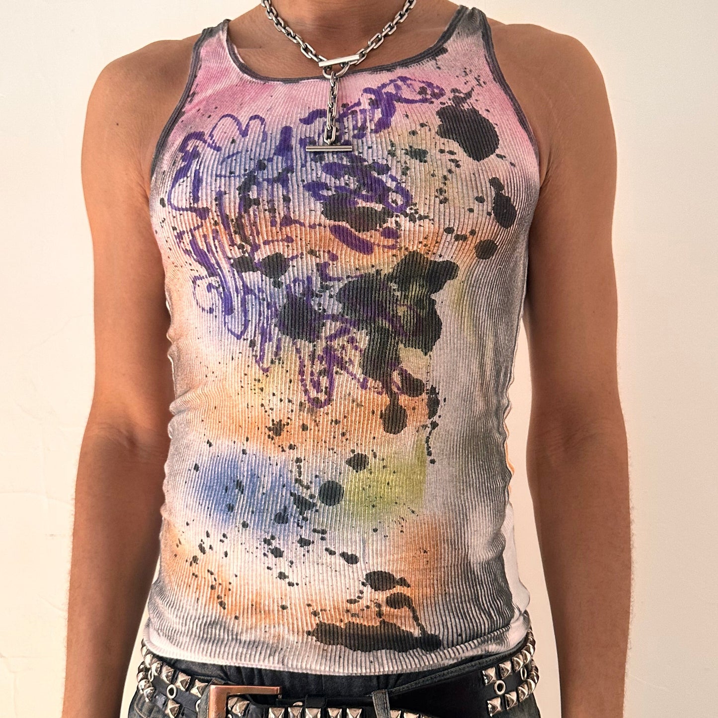 Close up of ASTROBOI* x Hanes 'Spectrum' white slim-fit tank top with hand-painted multicolored graffiti graphic print throughout, customized at ASTROBOI* STUDIO in NYC.