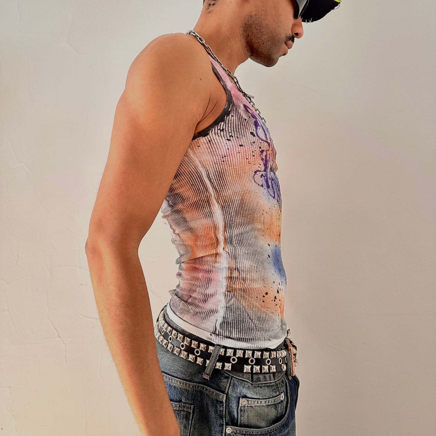 Right side of ASTROBOI* x Hanes 'Spectrum' white slim-fit tank top with hand-painted multicolored graffiti graphic print throughout, customized at ASTROBOI* STUDIO in NYC.