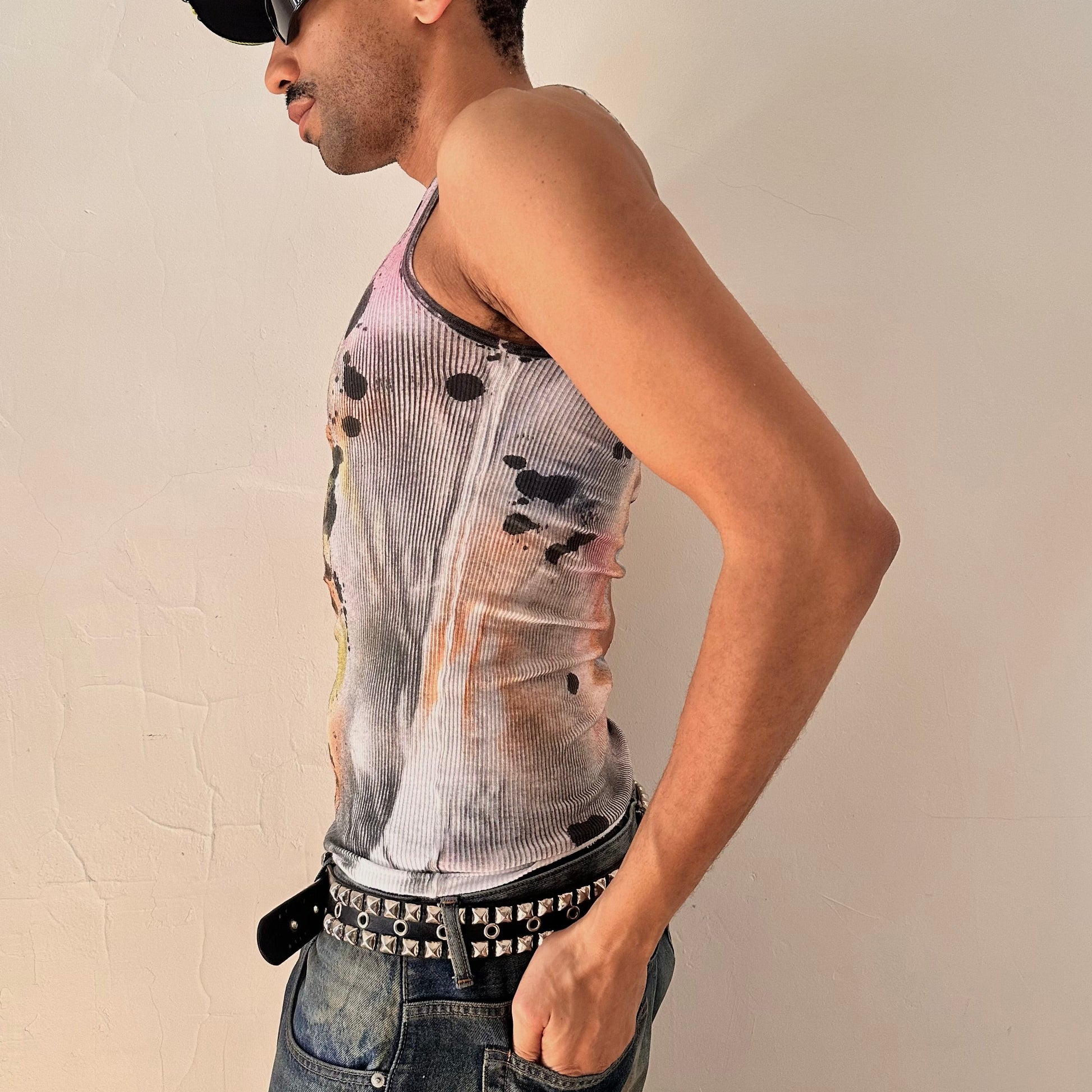Left side of ASTROBOI* x Hanes 'Spectrum' white slim-fit tank top with hand-painted multicolored graffiti graphic print throughout, customized at ASTROBOI* STUDIO in NYC.