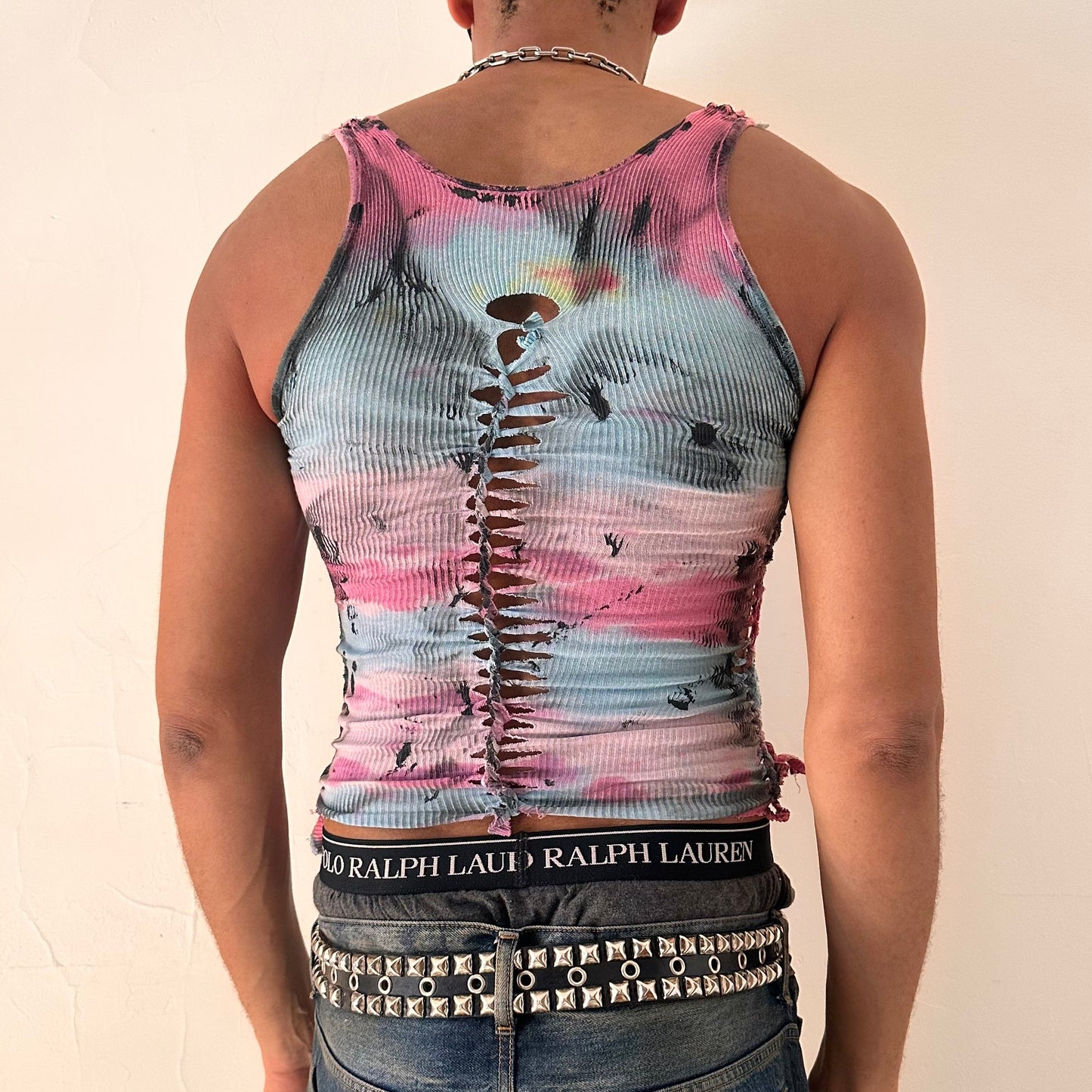 ASTROBOI* x Fruit of the Loom 'Sunrise' pink and blue tie dye braided twist tank top, rear view showing braid construction and tar paint detail, worn by male model.