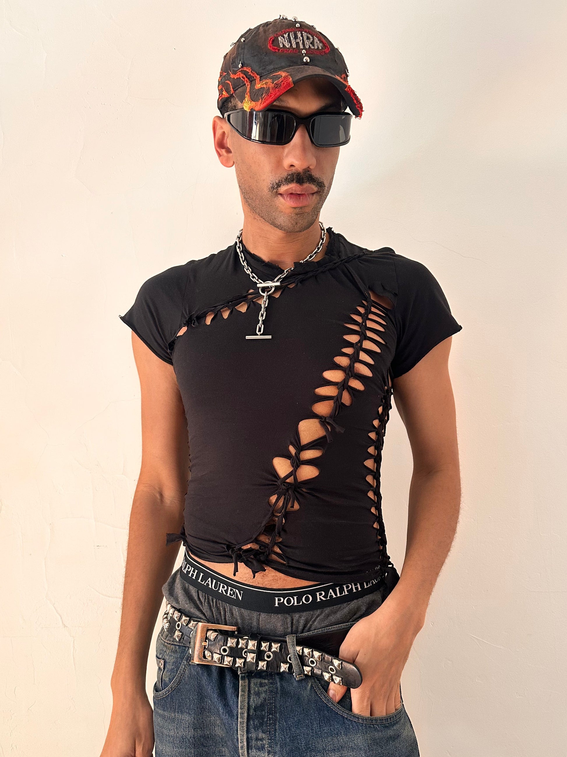 Styled image of ASTROBOI* x Calvin Klein black braided twist T-shirt in small with custom braided detailing and logo, soft cotton, NYC streetwear design.