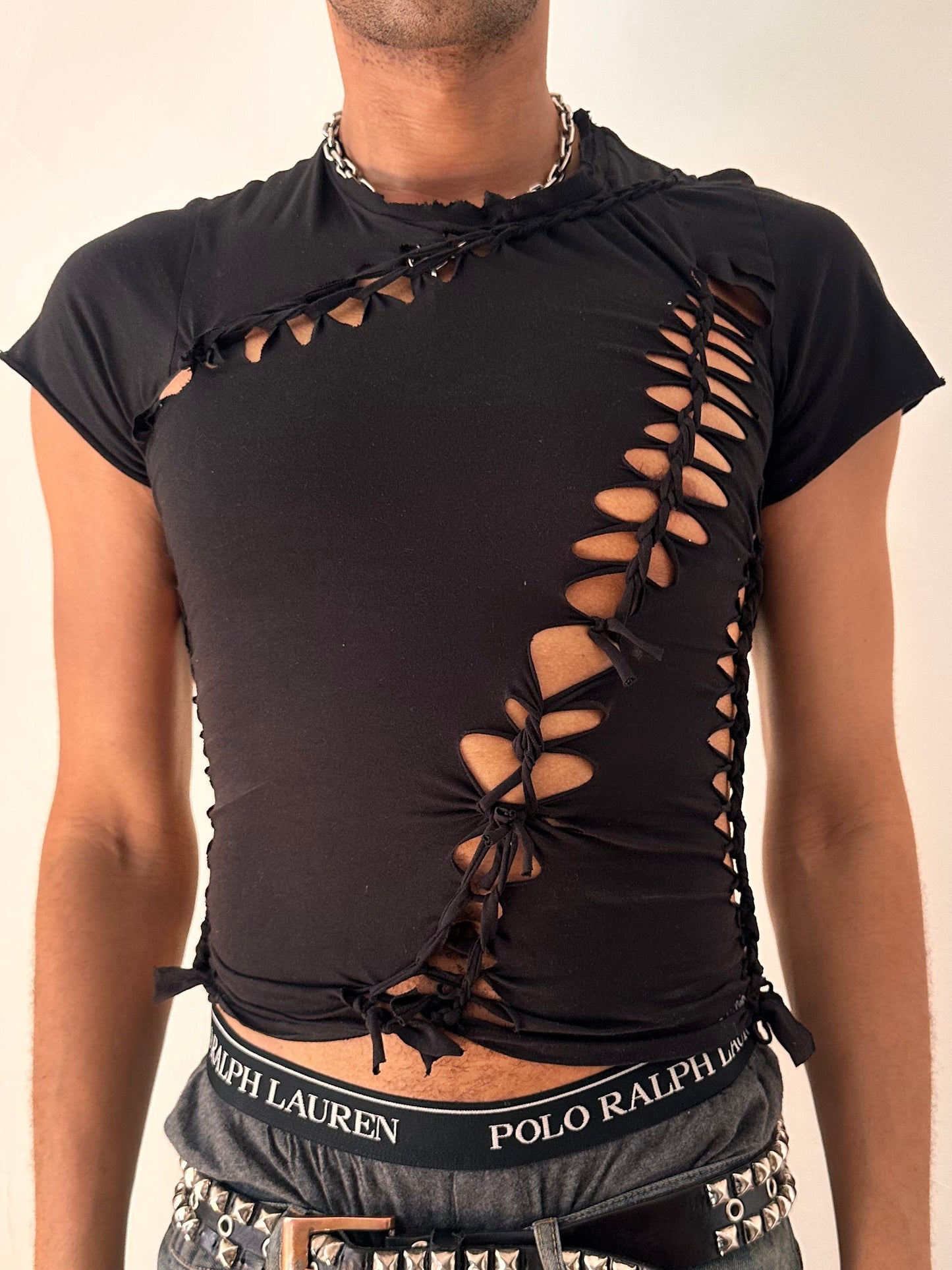 Close up of ASTROBOI* x Calvin Klein black braided twist T-shirt in small with custom braided detailing and logo, soft cotton, NYC streetwear design.