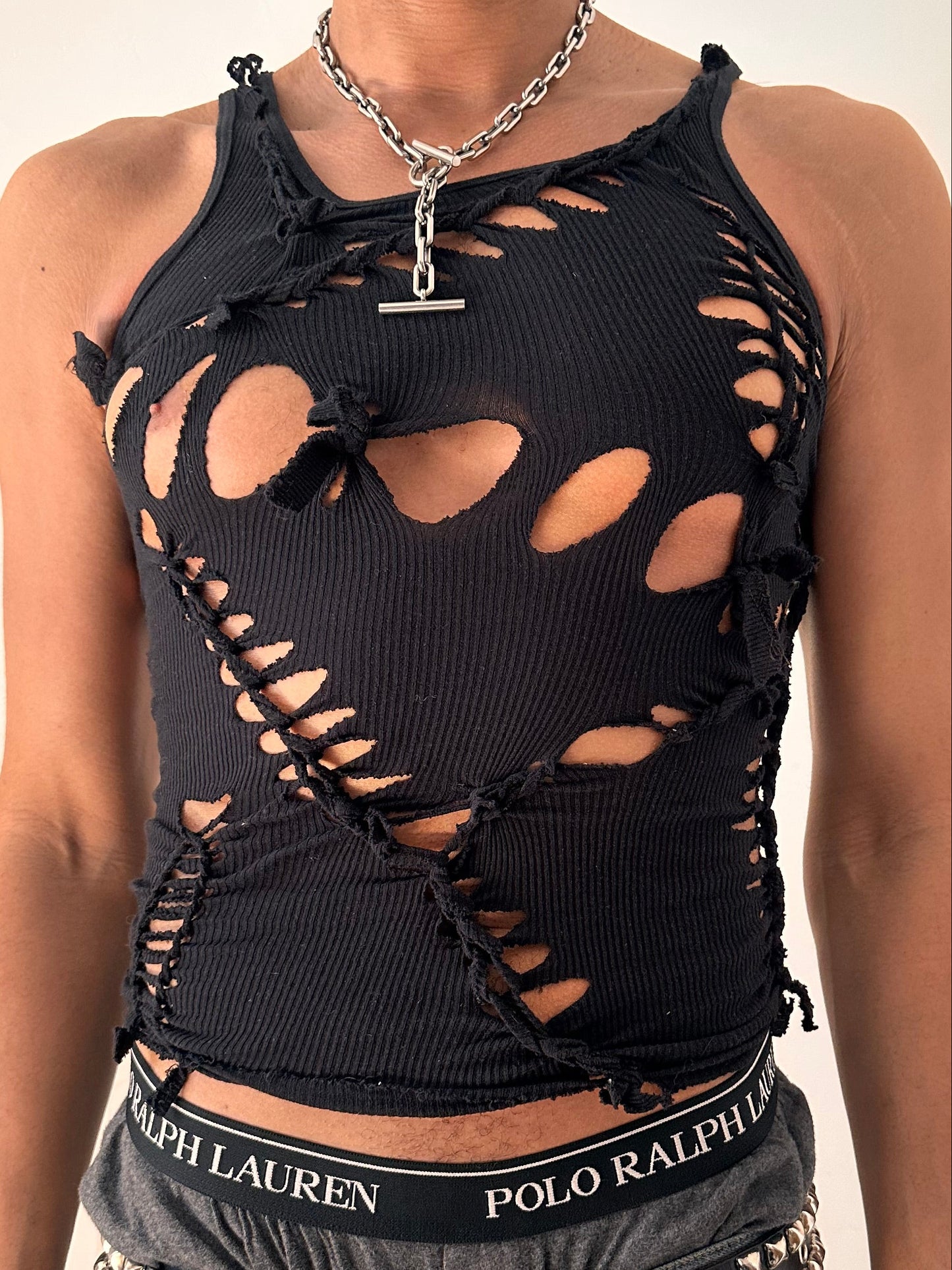 Close up of ASTROBOI* All Open black braided twist tank top with white painted design and slash detailing, form fitting silhouette, size Medium